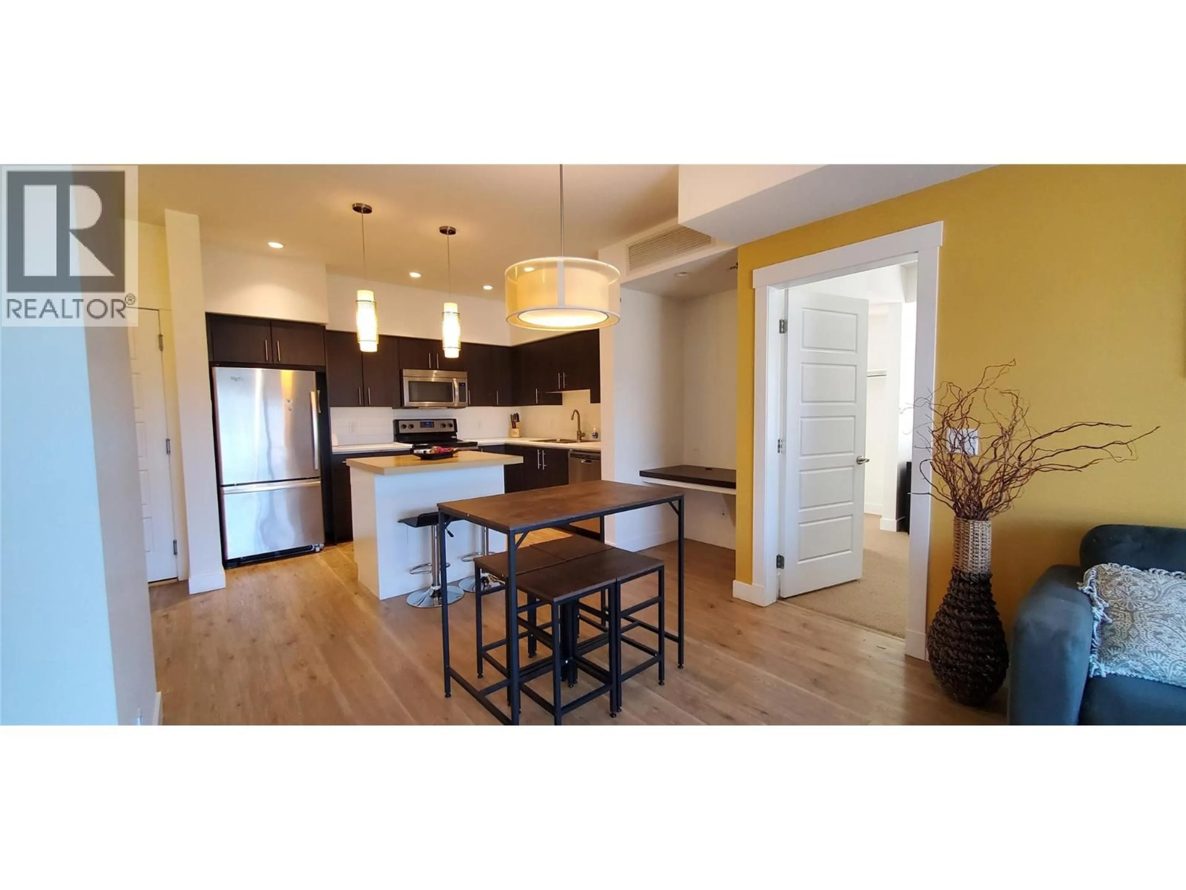 Open concept kitchen, wood/laminate floor for 401 - 975 ACADEMY WAY, Kelowna British Columbia V1V3C8