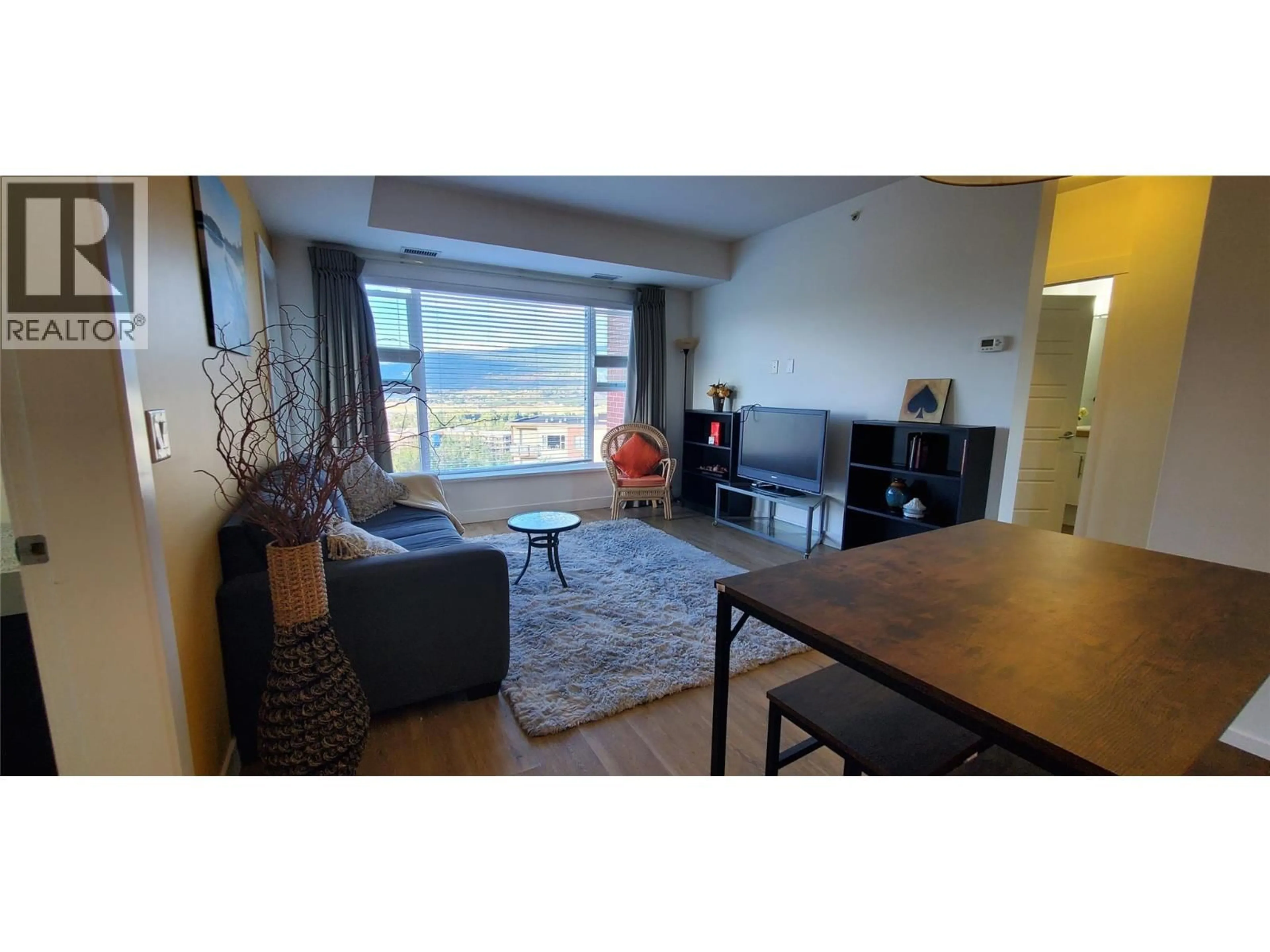 Living room with furniture, wood/laminate floor for 401 - 975 ACADEMY WAY, Kelowna British Columbia V1V3C8