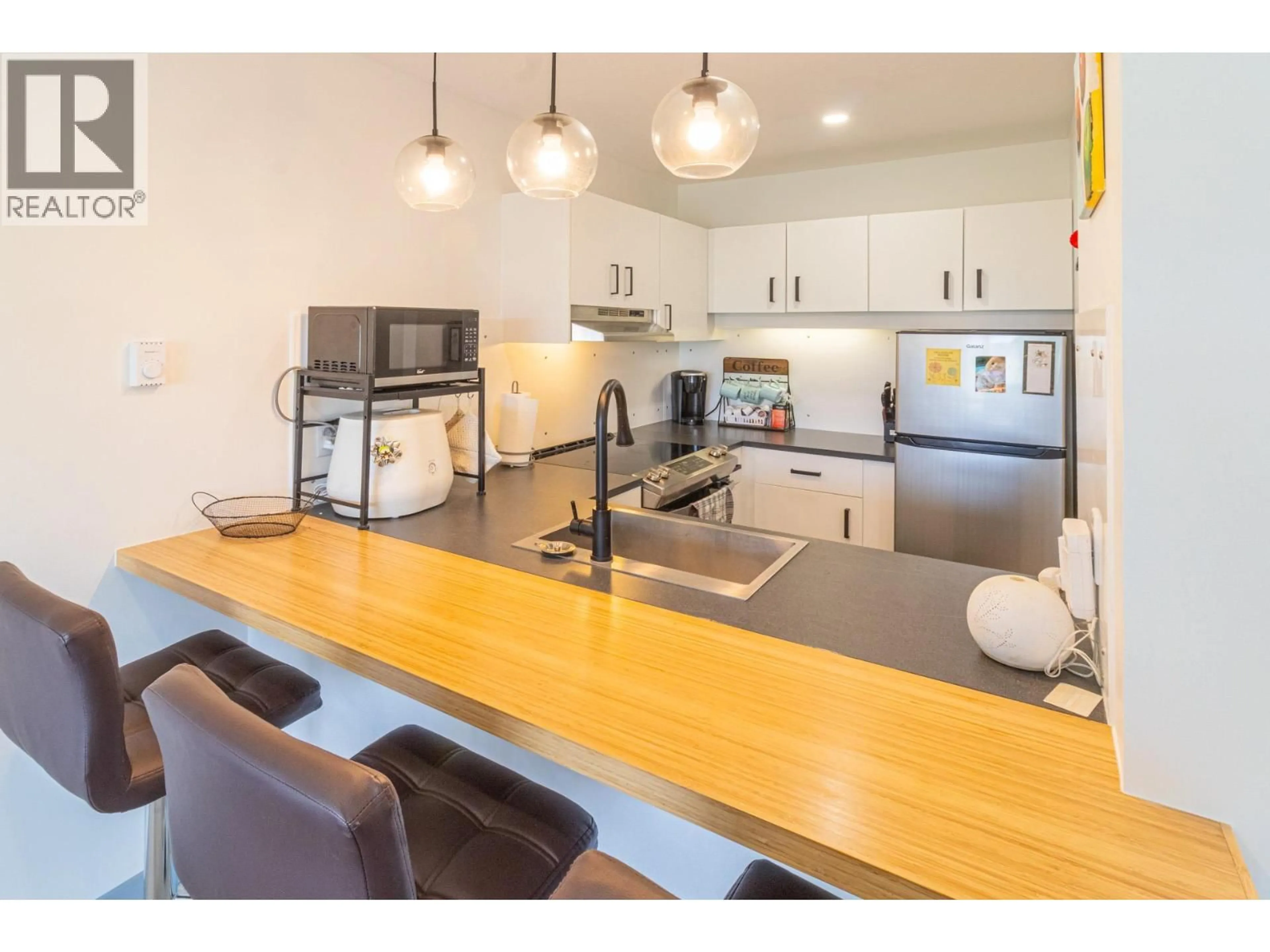 Open concept kitchen, wood/laminate floor for 1755 HURL STREET, Creston British Columbia V0B1G5