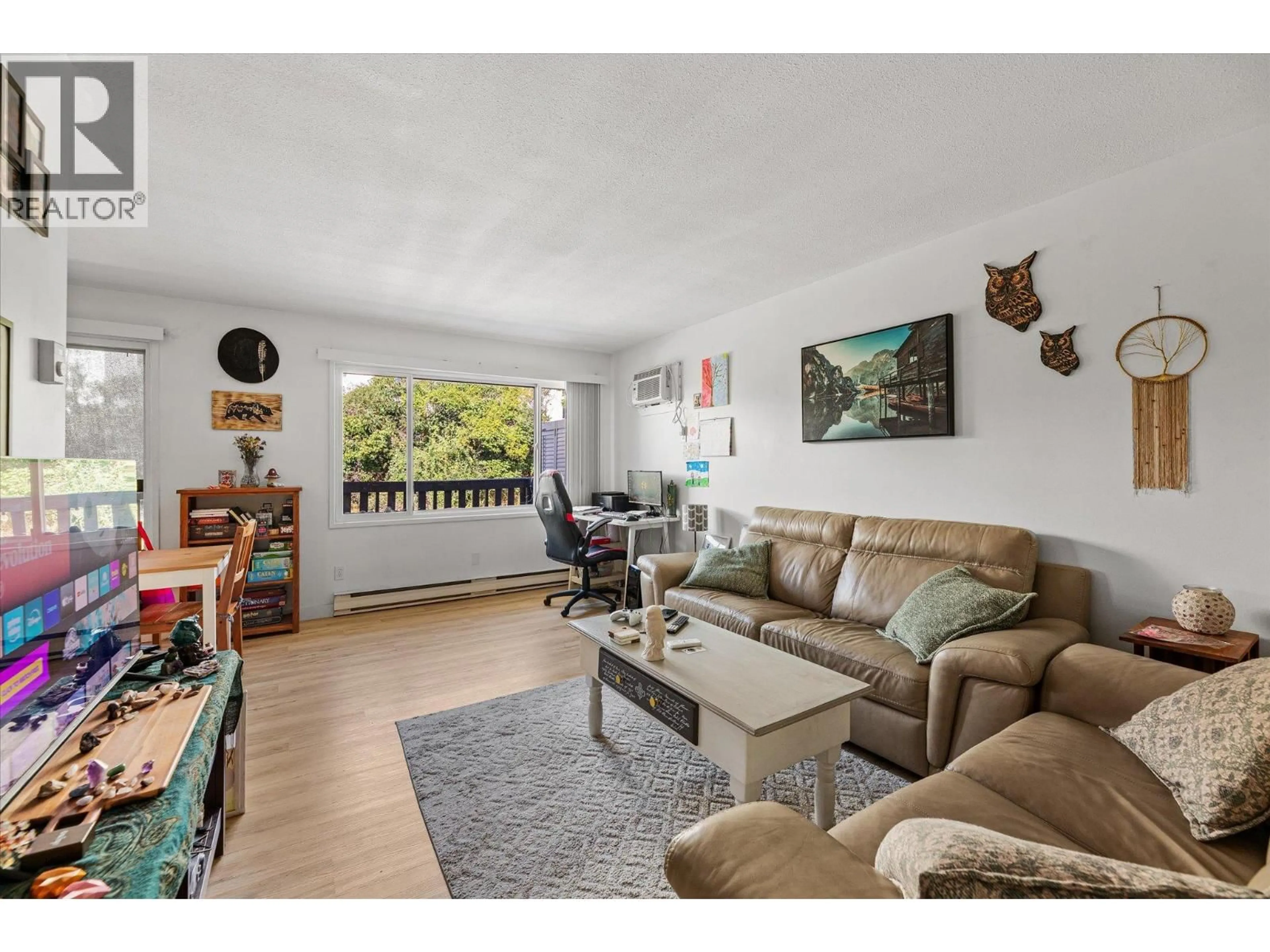 Living room with furniture, wood/laminate floor for 228 - 3505 38 STREET, Vernon British Columbia V1T6X1