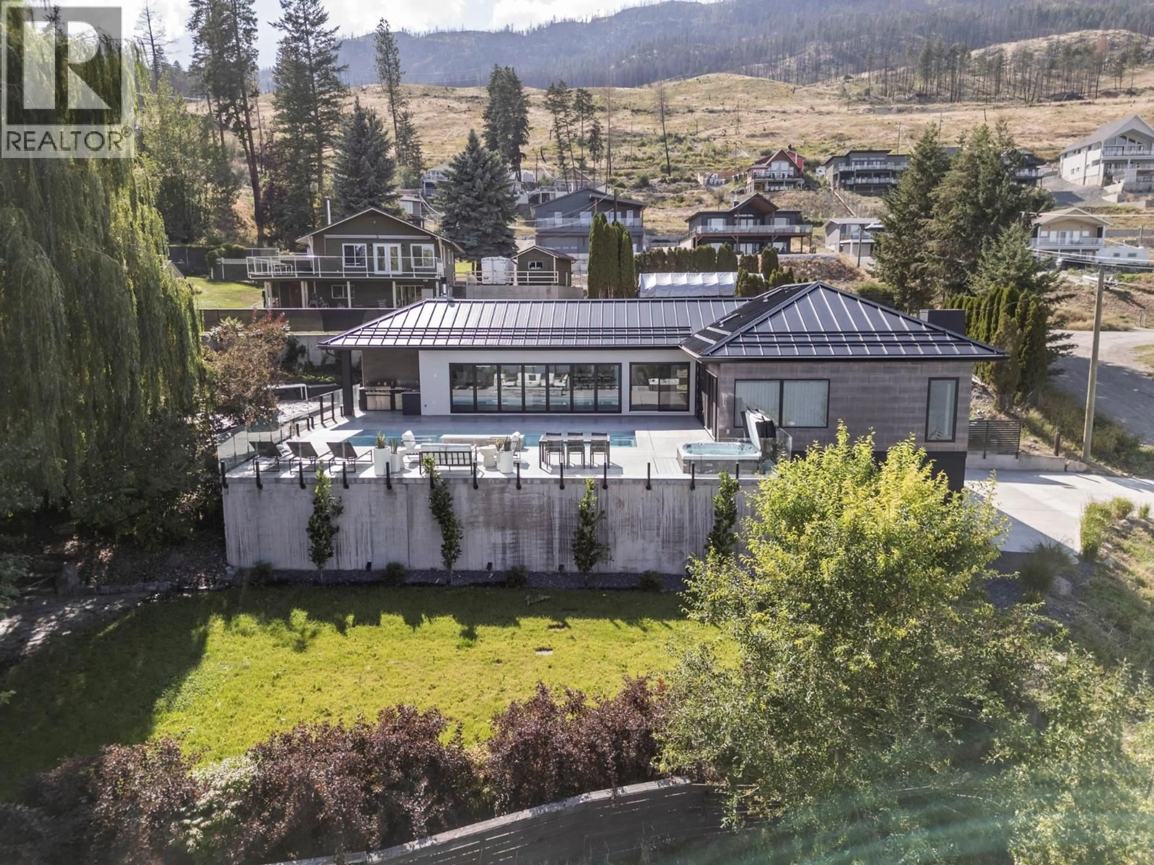 A pic from outside/outdoor area/front of a property/back of a property/a pic from drone, mountain view for 104 ELLIOT ROAD, Vernon British Columbia V1H2E4