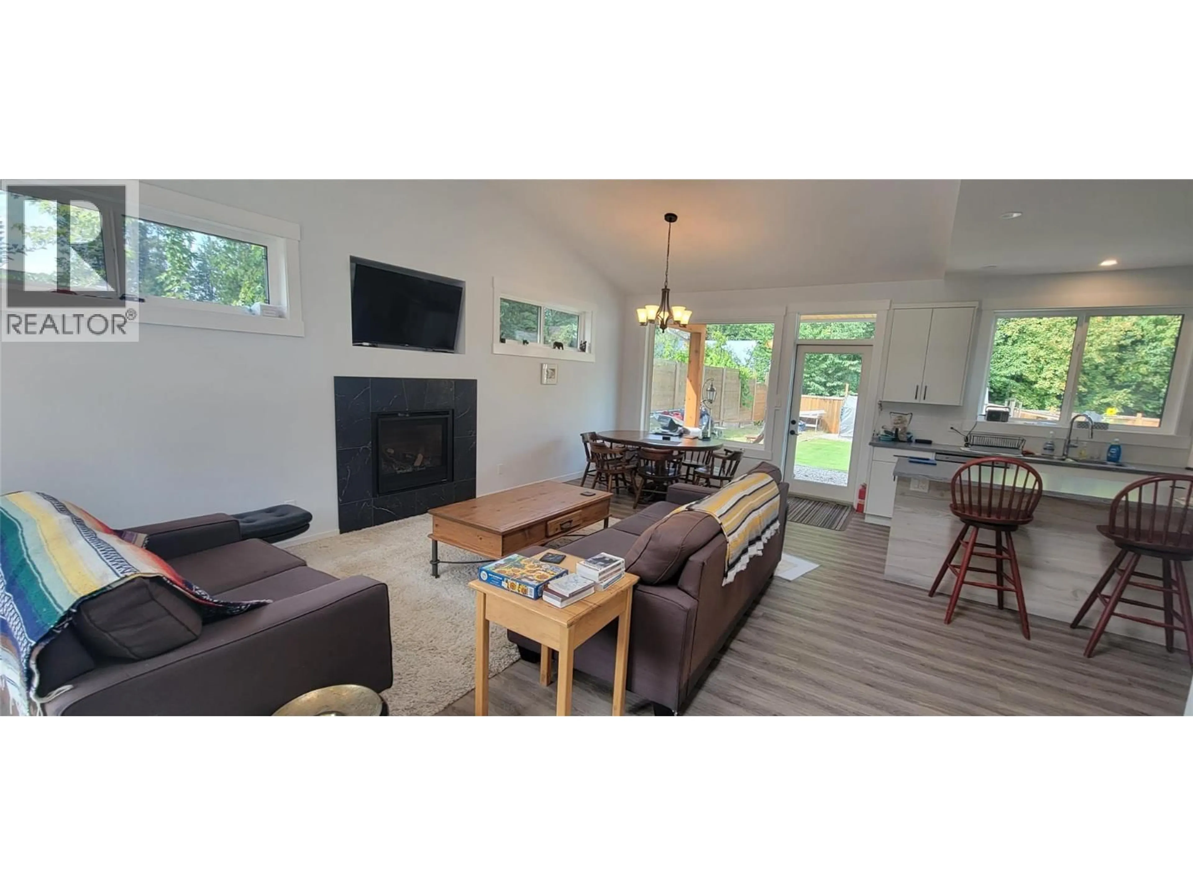 Living room with furniture, wood/laminate floor for 611 HUME STREET, Slocan British Columbia V0G2C0