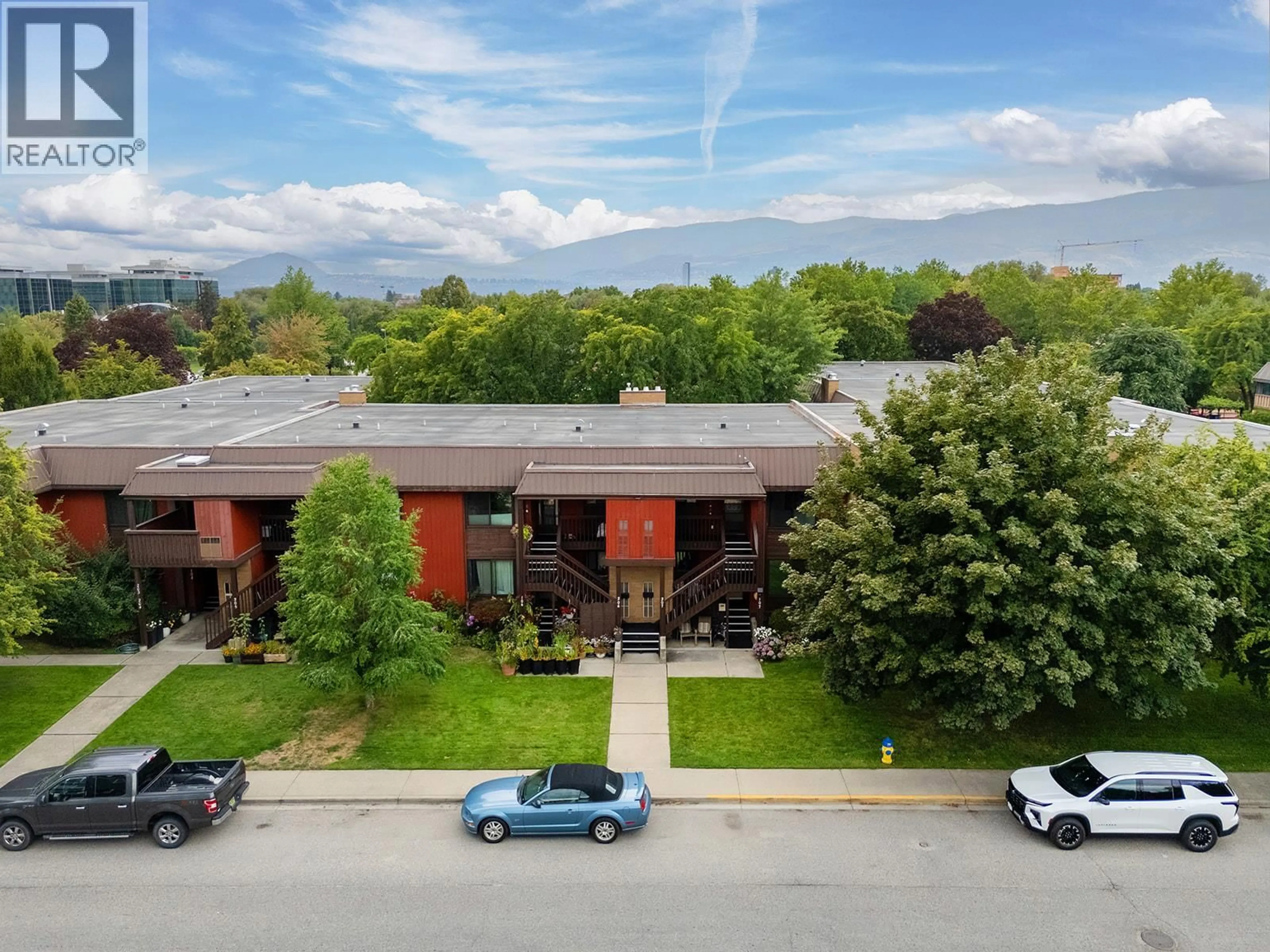 A pic from outside/outdoor area/front of a property/back of a property/a pic from drone, mountain view for 206 - 1870 PARKINSON WAY, Kelowna British Columbia V1Y8C9