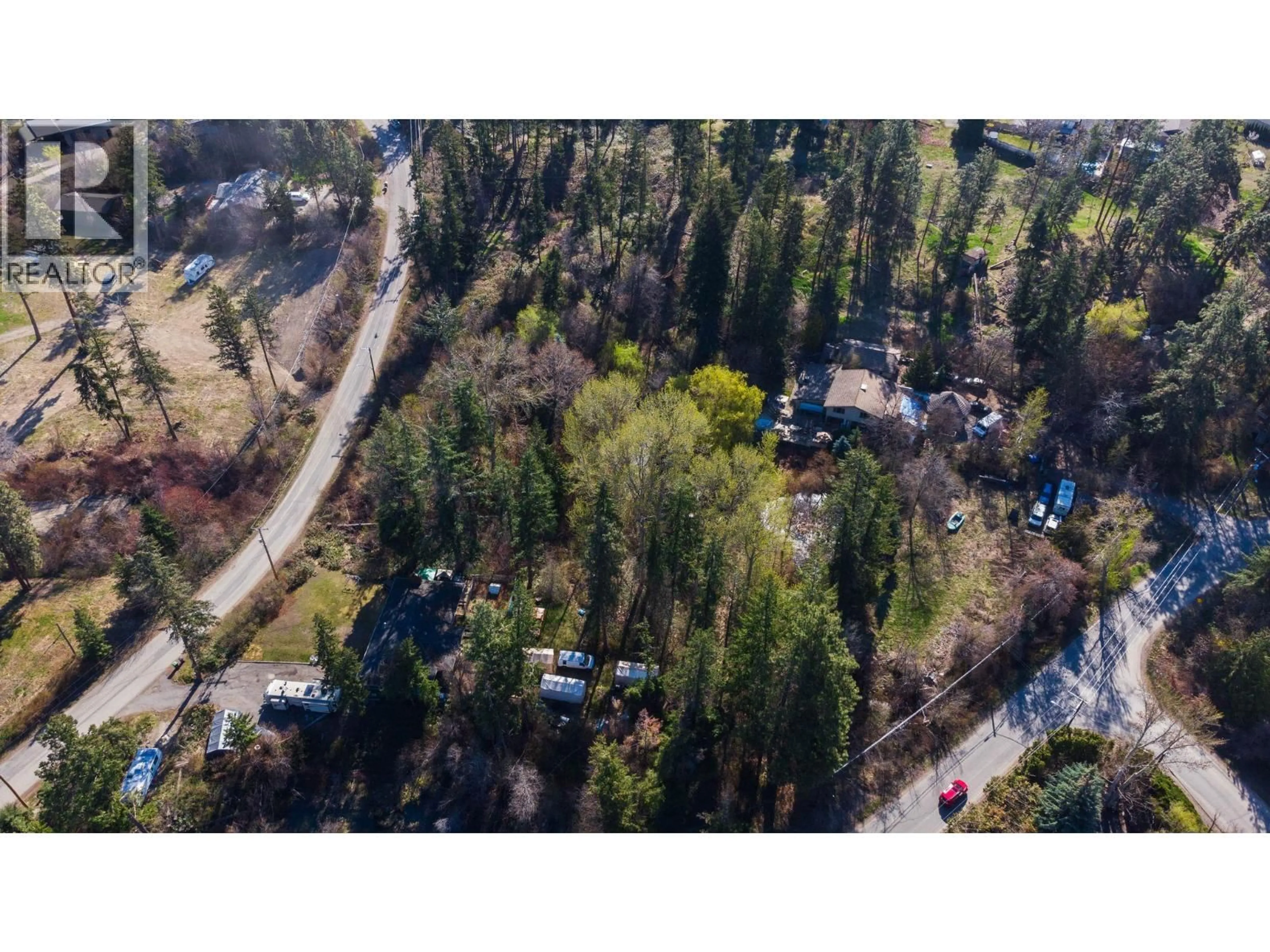 A pic from outside/outdoor area/front of a property/back of a property/a pic from drone, forest/trees view for 3281 HALL ROAD, Kelowna British Columbia V1W2V1