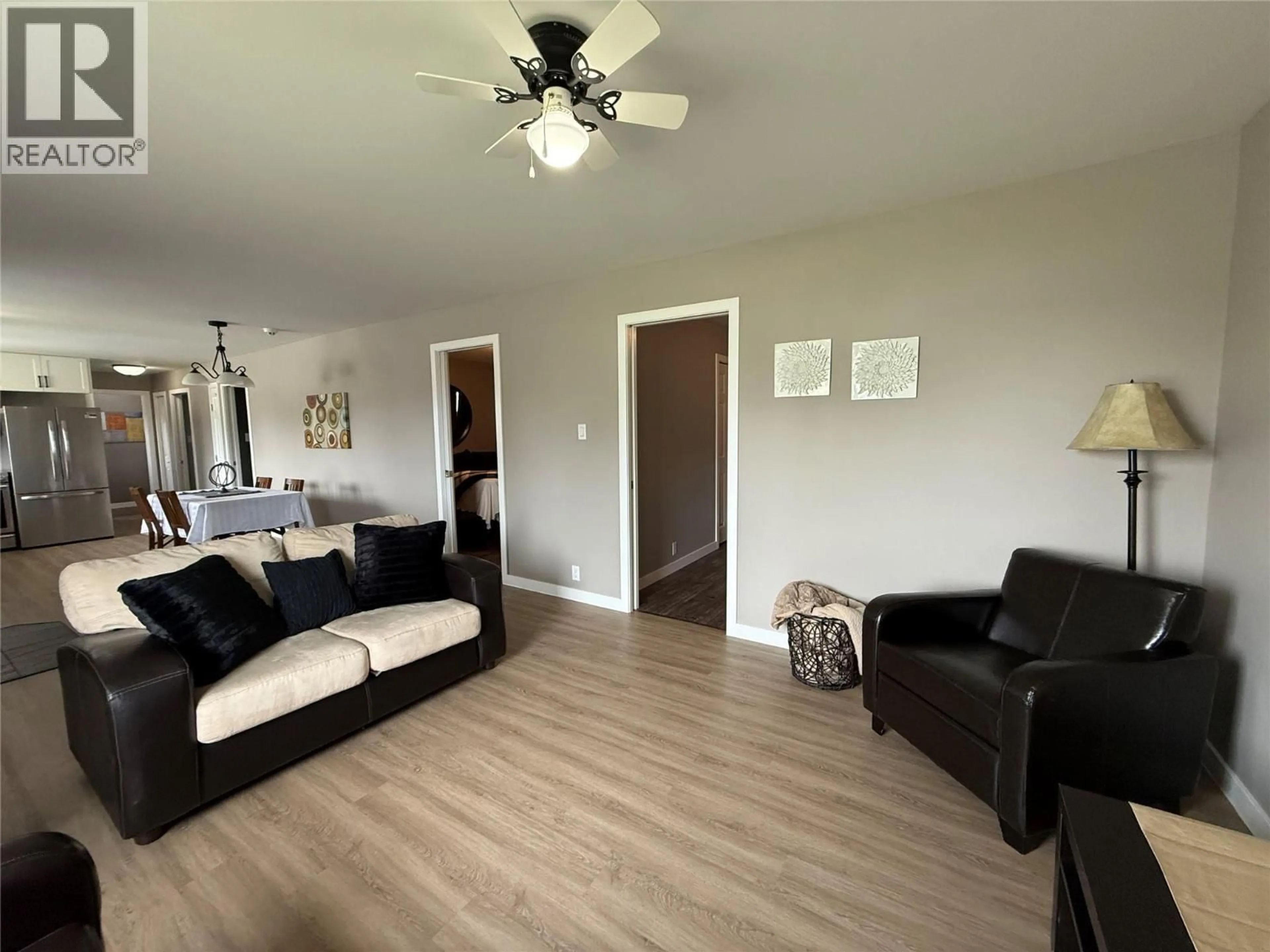 Living room with furniture, wood/laminate floor for 913 111 AVENUE, Dawson Creek British Columbia V1G2X4
