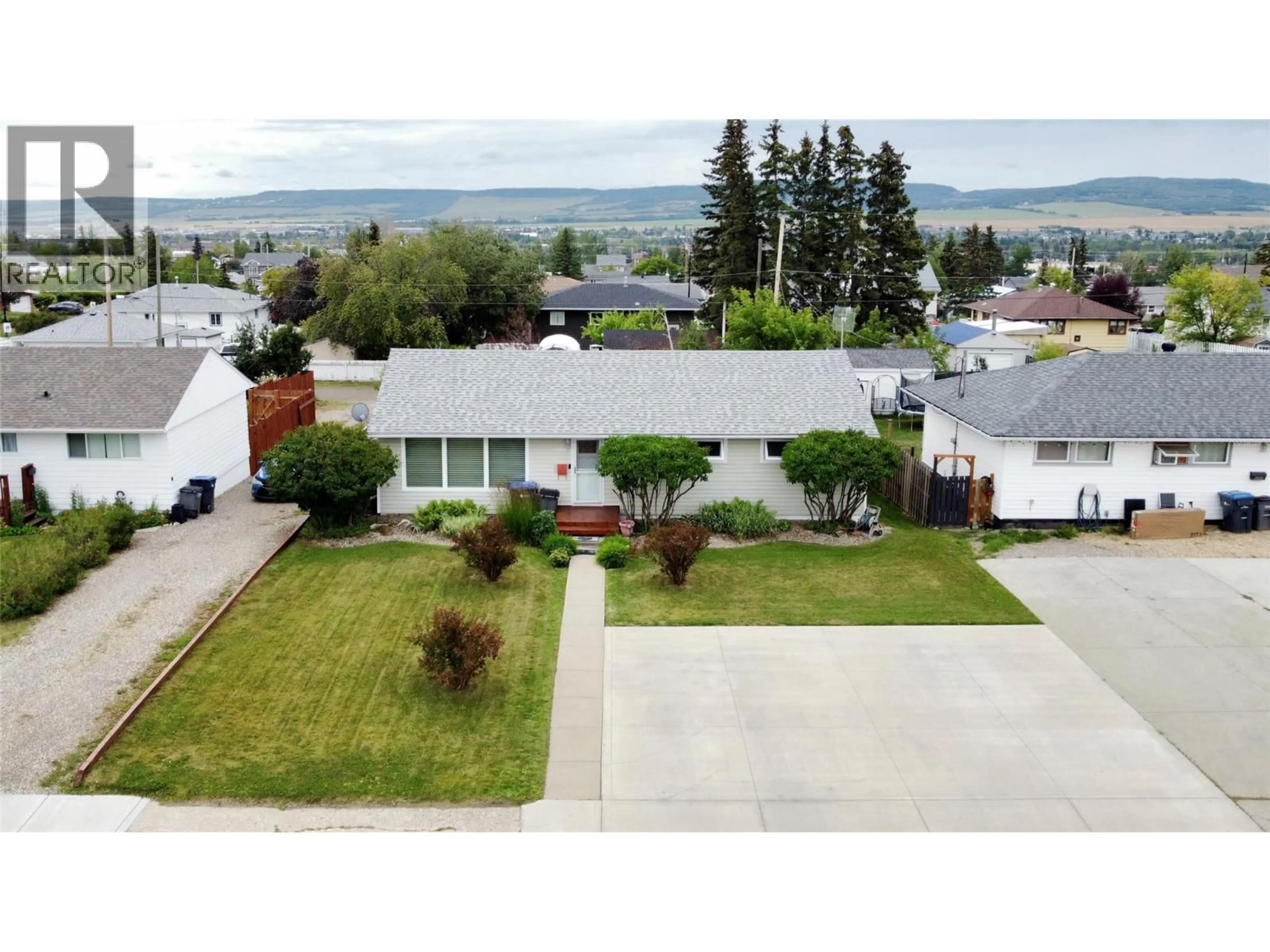 A pic from outside/outdoor area/front of a property/back of a property/a pic from drone, mountain view for 1309 93 AVENUE, Dawson Creek British Columbia V1G1E5