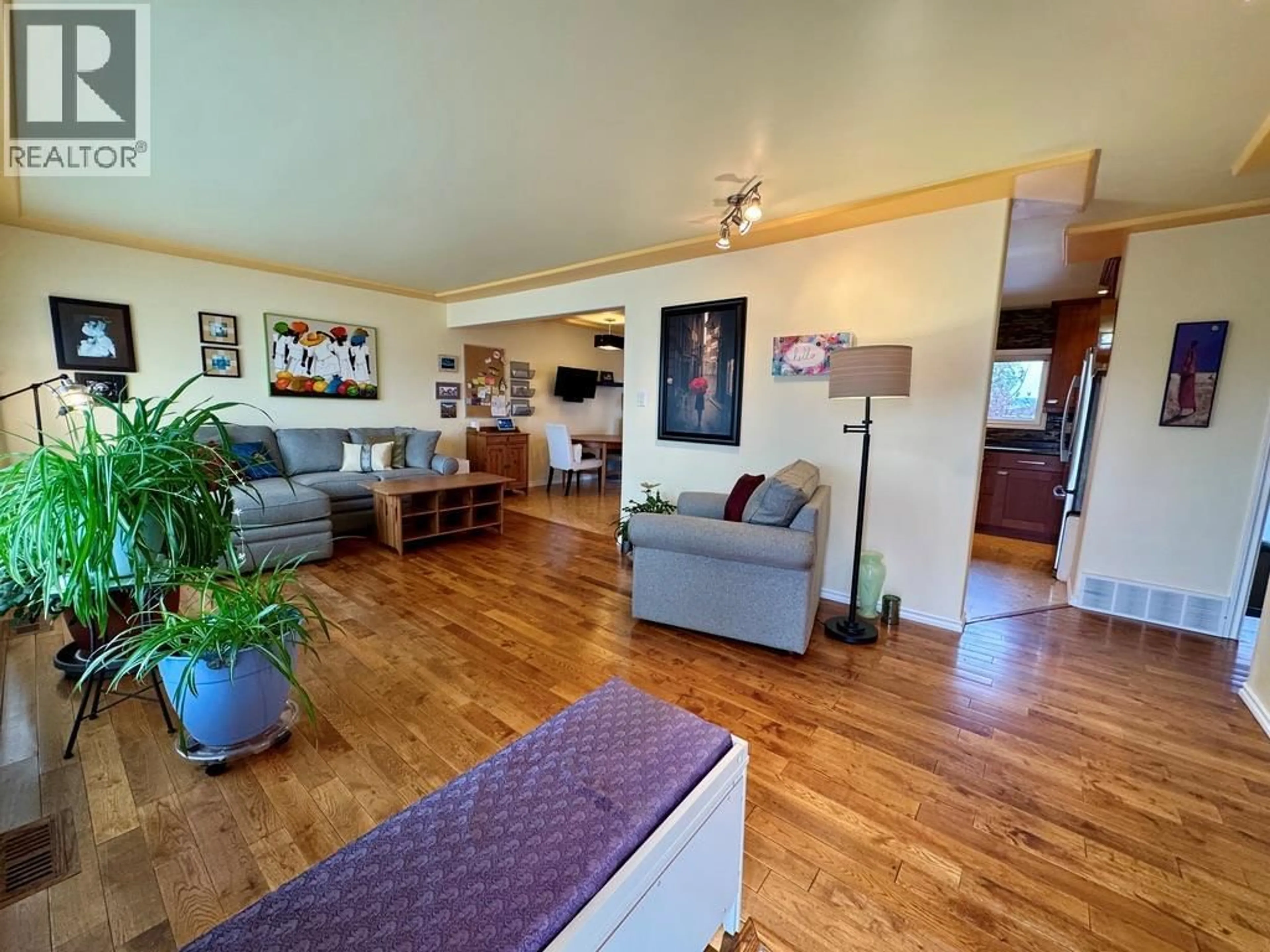 Living room with furniture, wood/laminate floor for 1309 93 AVENUE, Dawson Creek British Columbia V1G1E5