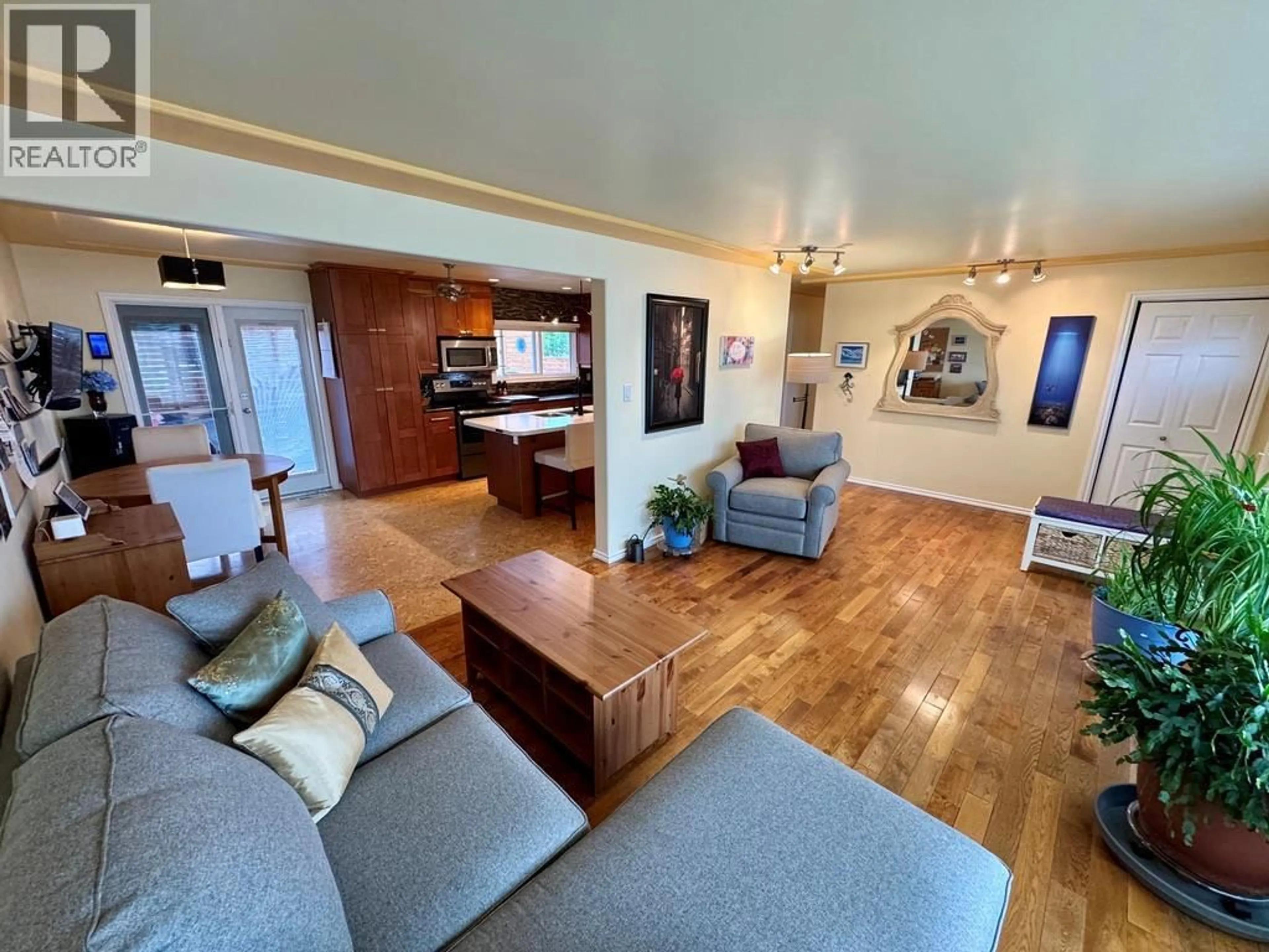 Living room with furniture, wood/laminate floor for 1309 93 AVENUE, Dawson Creek British Columbia V1G1E5