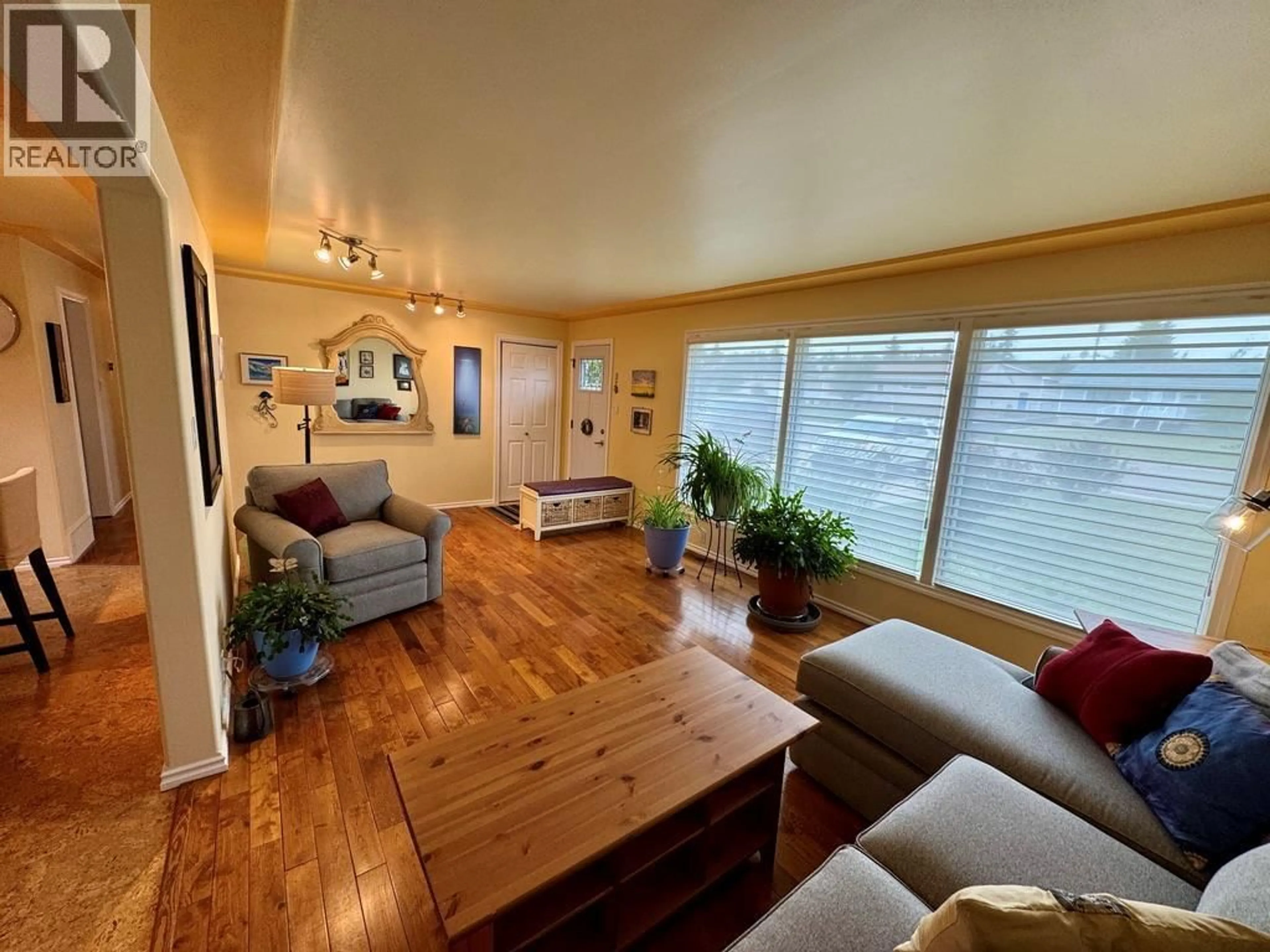 Living room with furniture, wood/laminate floor for 1309 93 AVENUE, Dawson Creek British Columbia V1G1E5