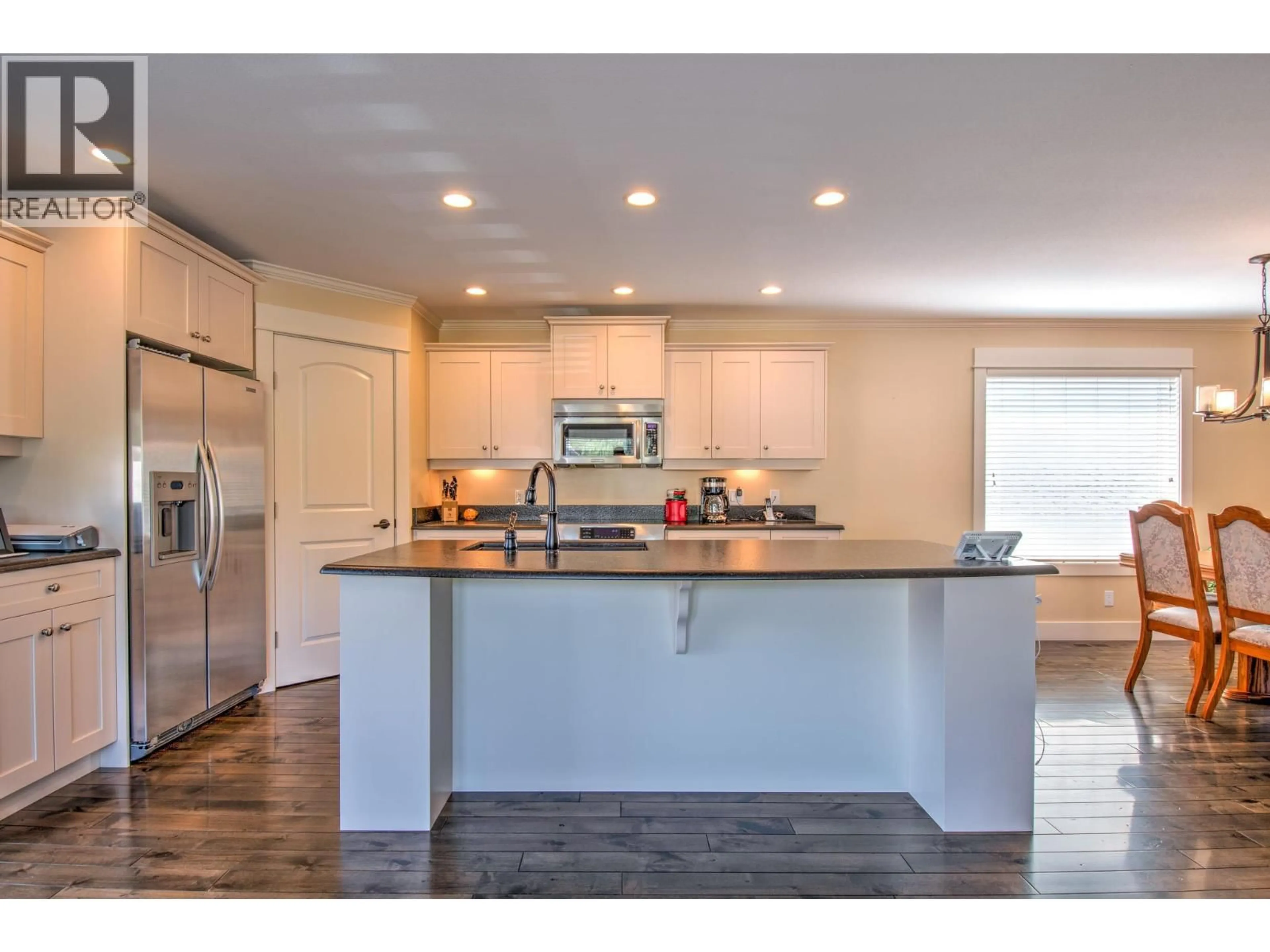 Open concept kitchen, wood/laminate floor for 5409 WILLOW DRIVE, Vernon British Columbia V1T2E4