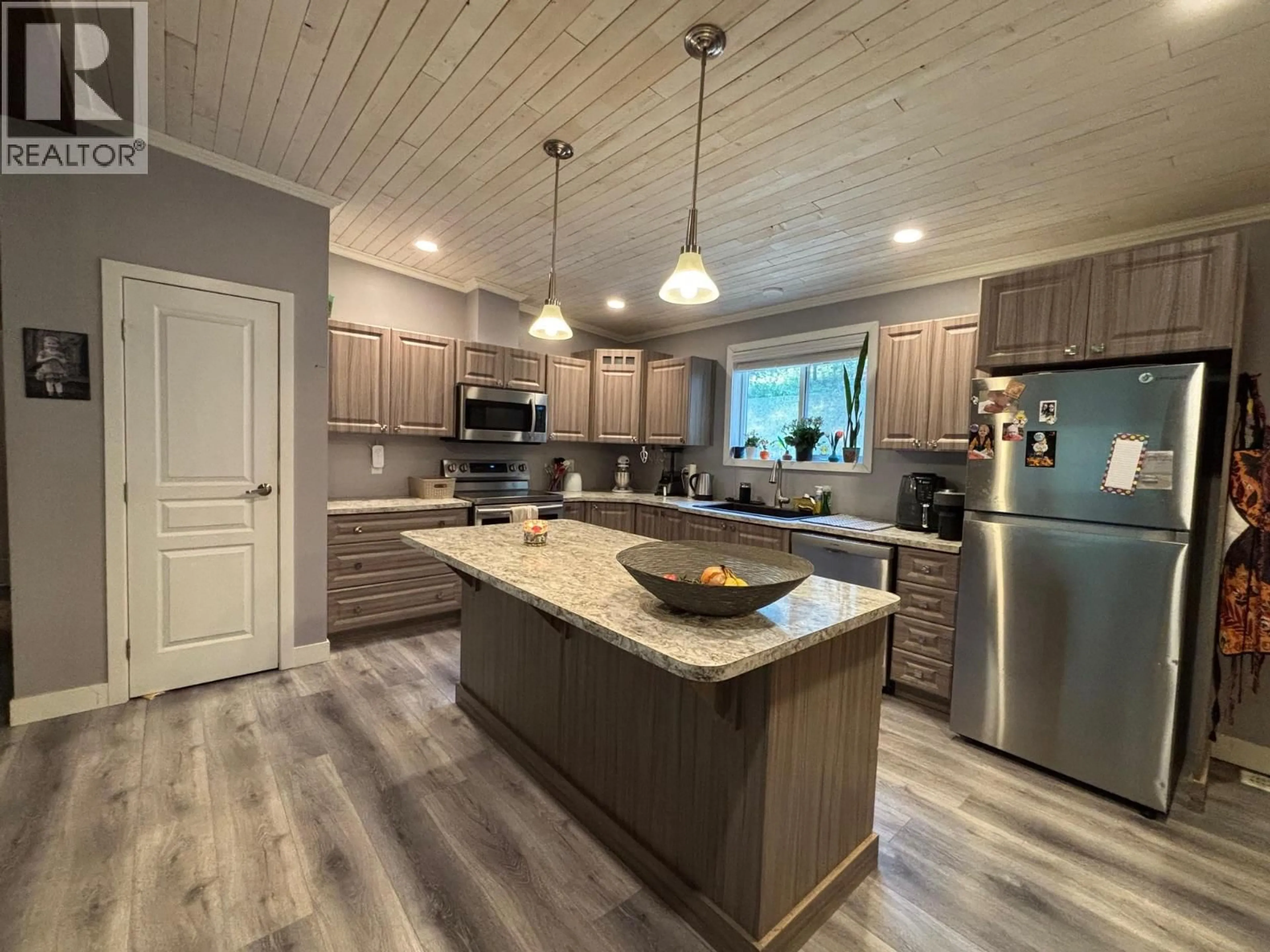 Open concept kitchen, wood/laminate floor for 3520 33 HIGHWAY, Westbridge British Columbia V0H1Y0