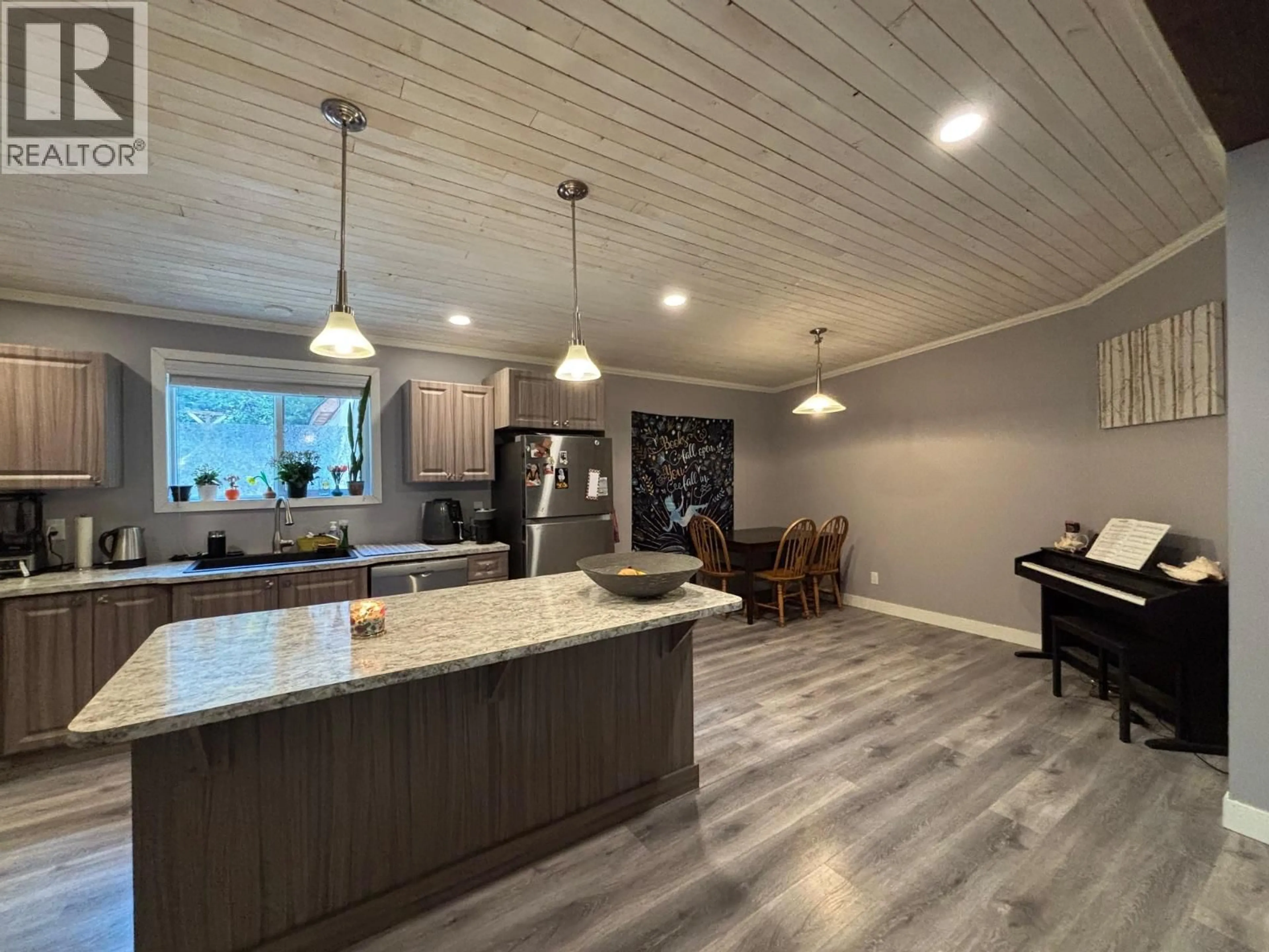 Open concept kitchen, wood/laminate floor for 3520 33 HIGHWAY, Westbridge British Columbia V0H1Y0