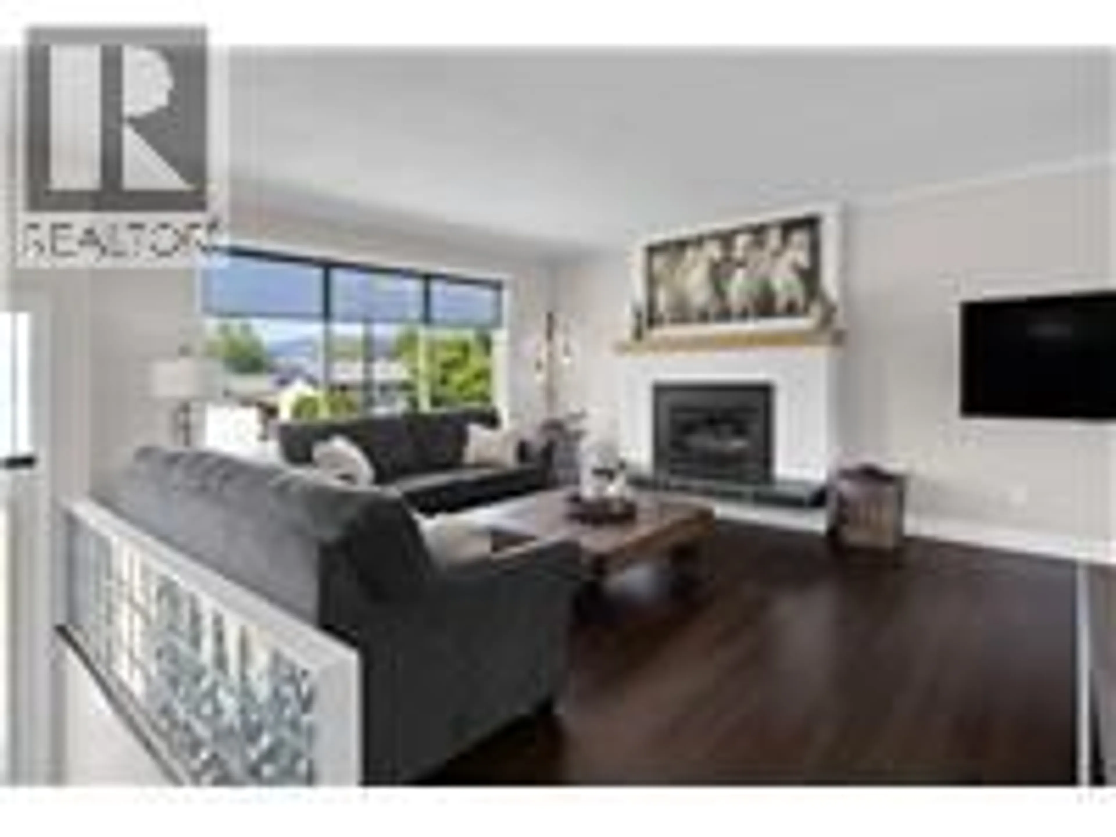 Living room with furniture, wood/laminate floor for 4479 WASILOW ROAD, Kelowna British Columbia V1W1R7