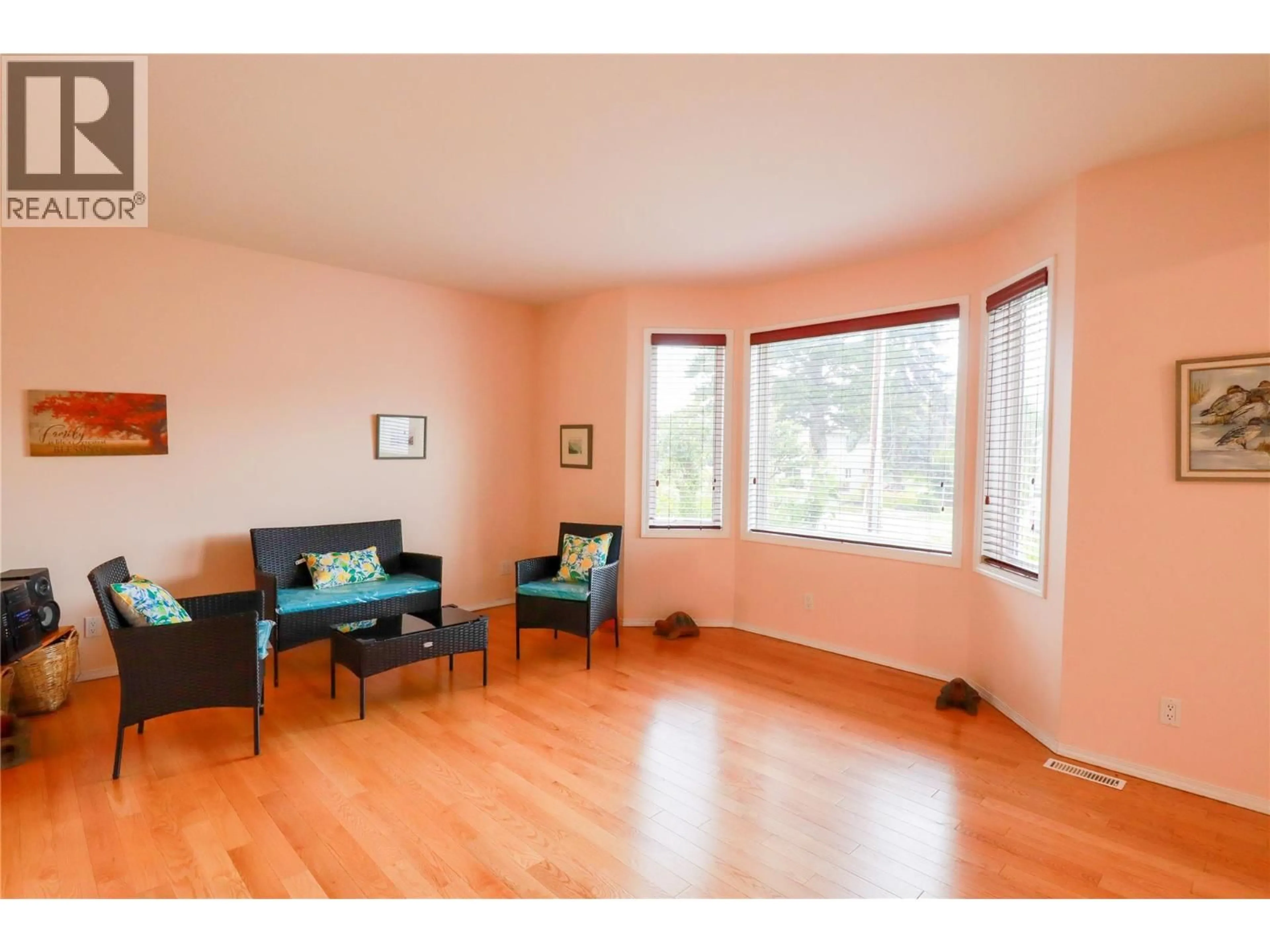 Living room with furniture, wood/laminate floor for 7513 HIGGIN AVENUE, Summerland British Columbia V0H1Z6