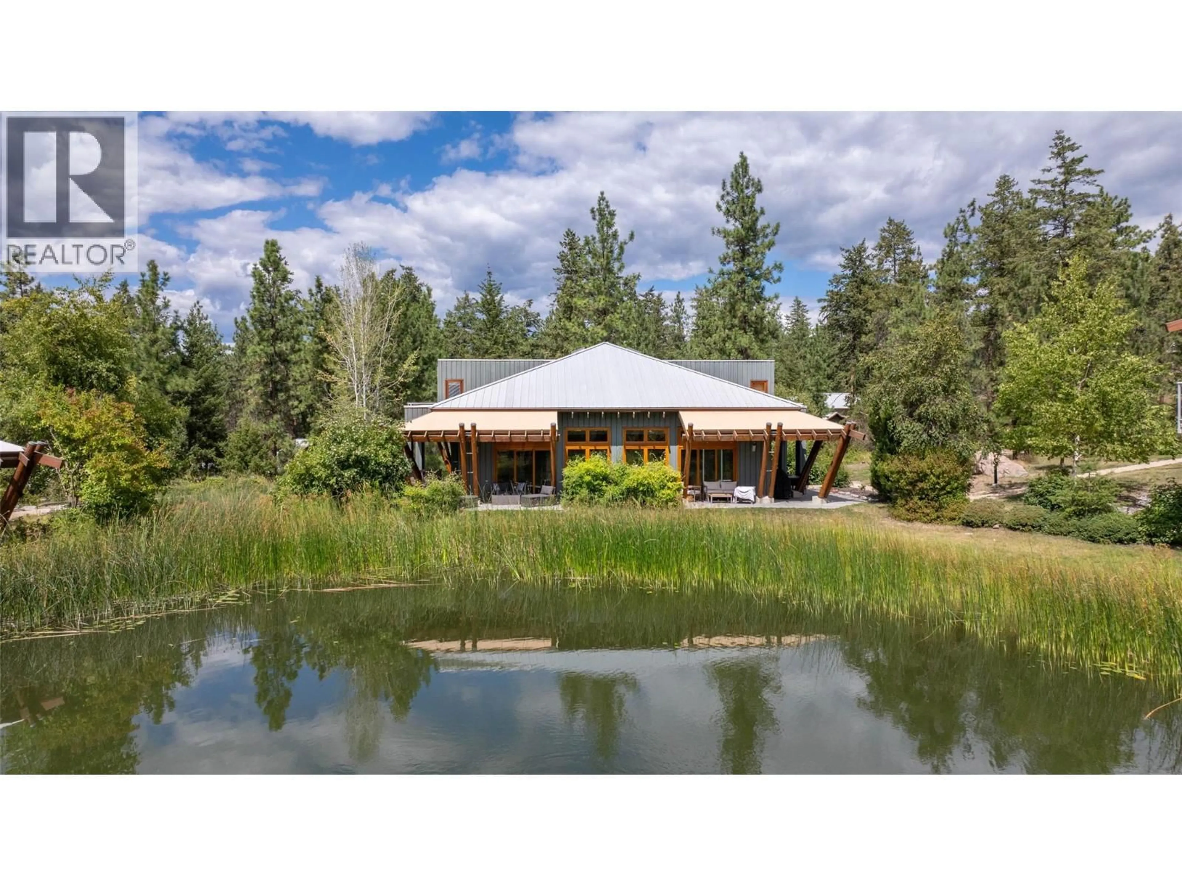 A pic from outside/outdoor area/front of a property/back of a property/a pic from drone, water/lake/river/ocean view for 97 - 9845 EASTSIDE ROAD, Vernon British Columbia V1H1Z2