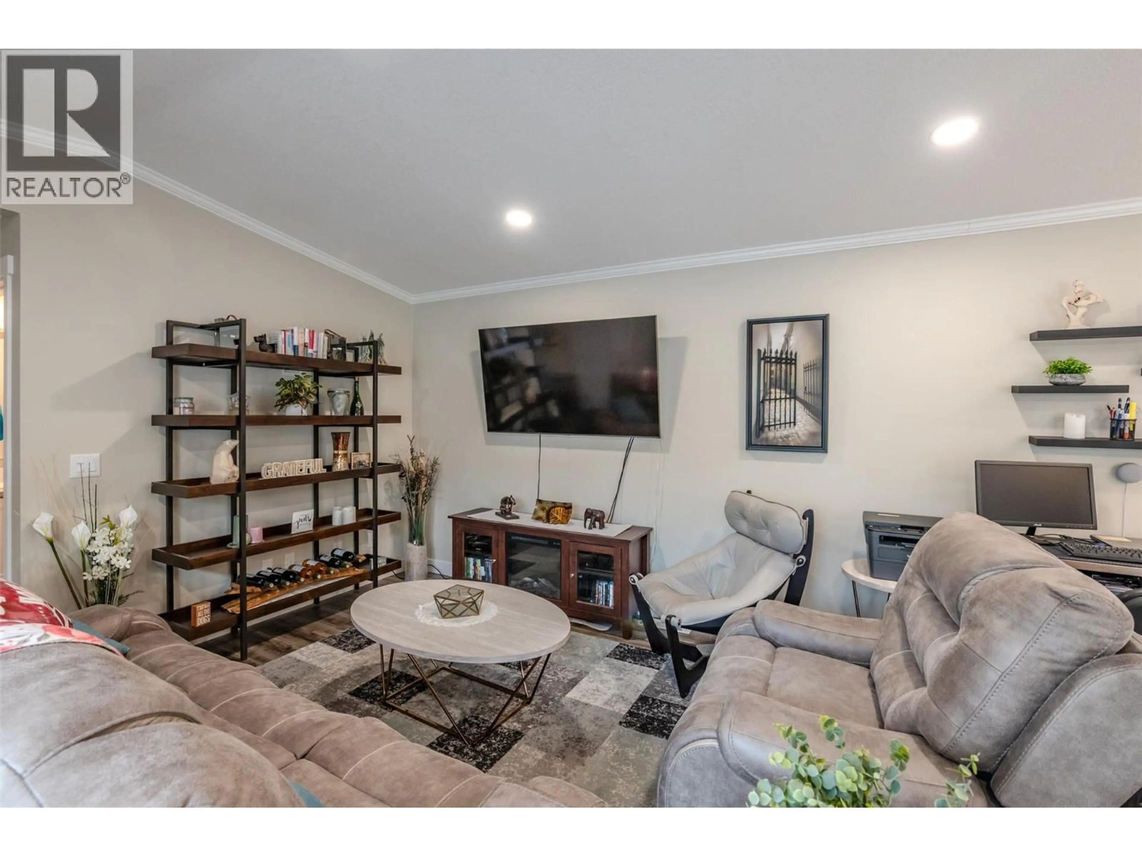 Living room with furniture, wood/laminate floor for 102 - 8598 HWY 97 OTHER, Oliver British Columbia V0H1T2