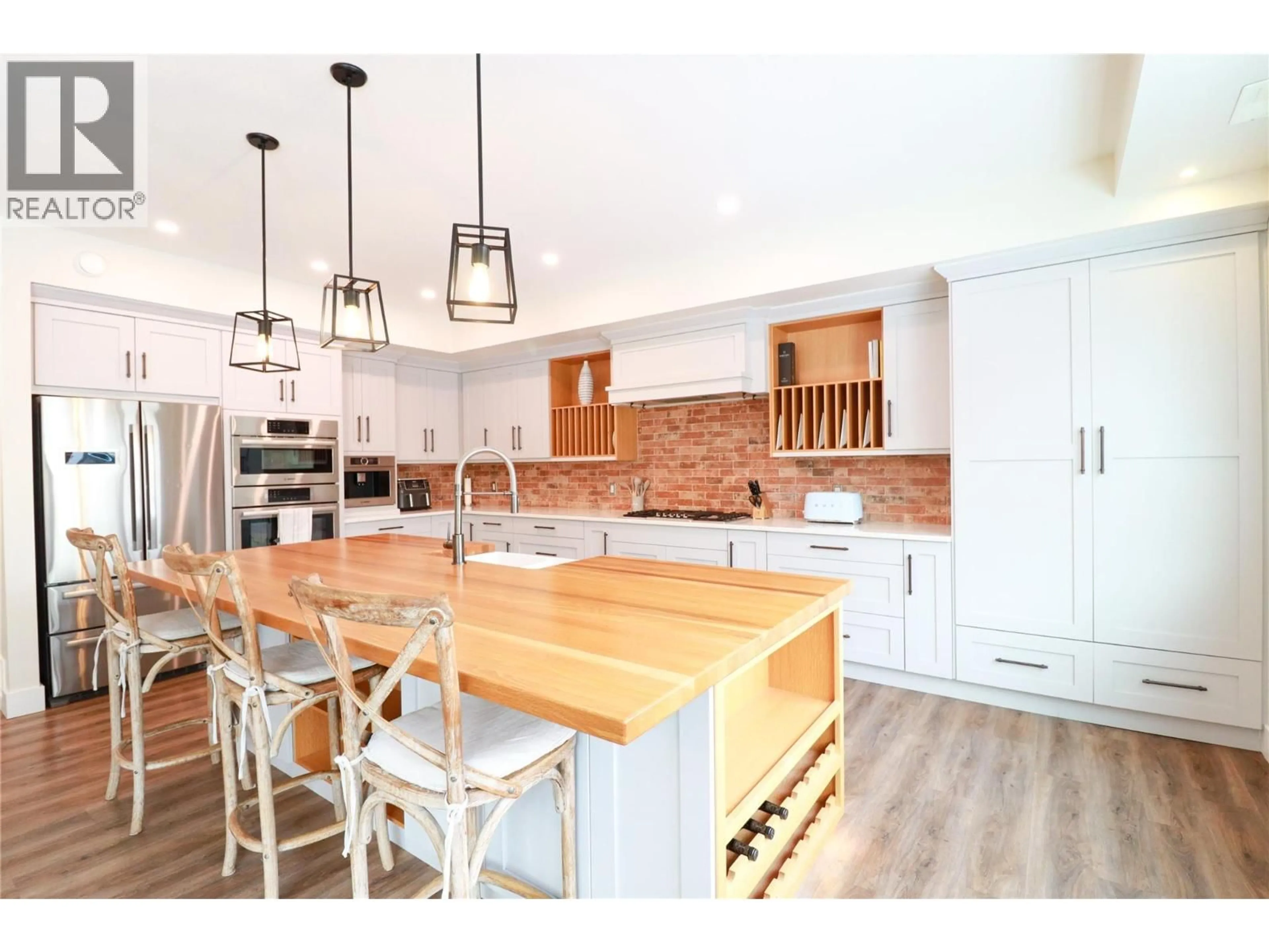 Open concept kitchen, wood/laminate floor for 884 JOHNSON STREET, Summerland British Columbia V0H1Z9