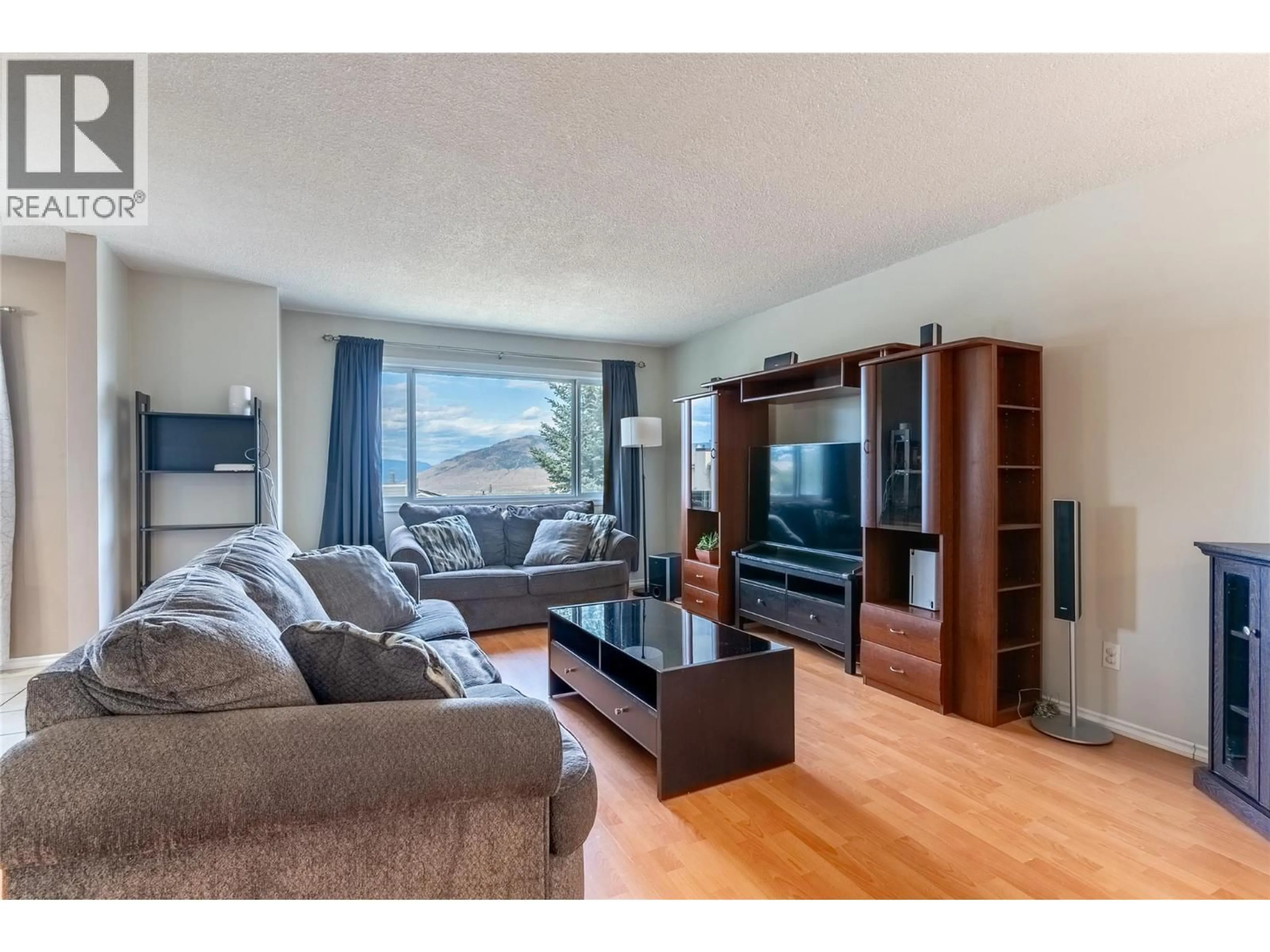 Living room with furniture, wood/laminate floor for 399 WADDINGTON DRIVE, Kamloops British Columbia V2E1S3