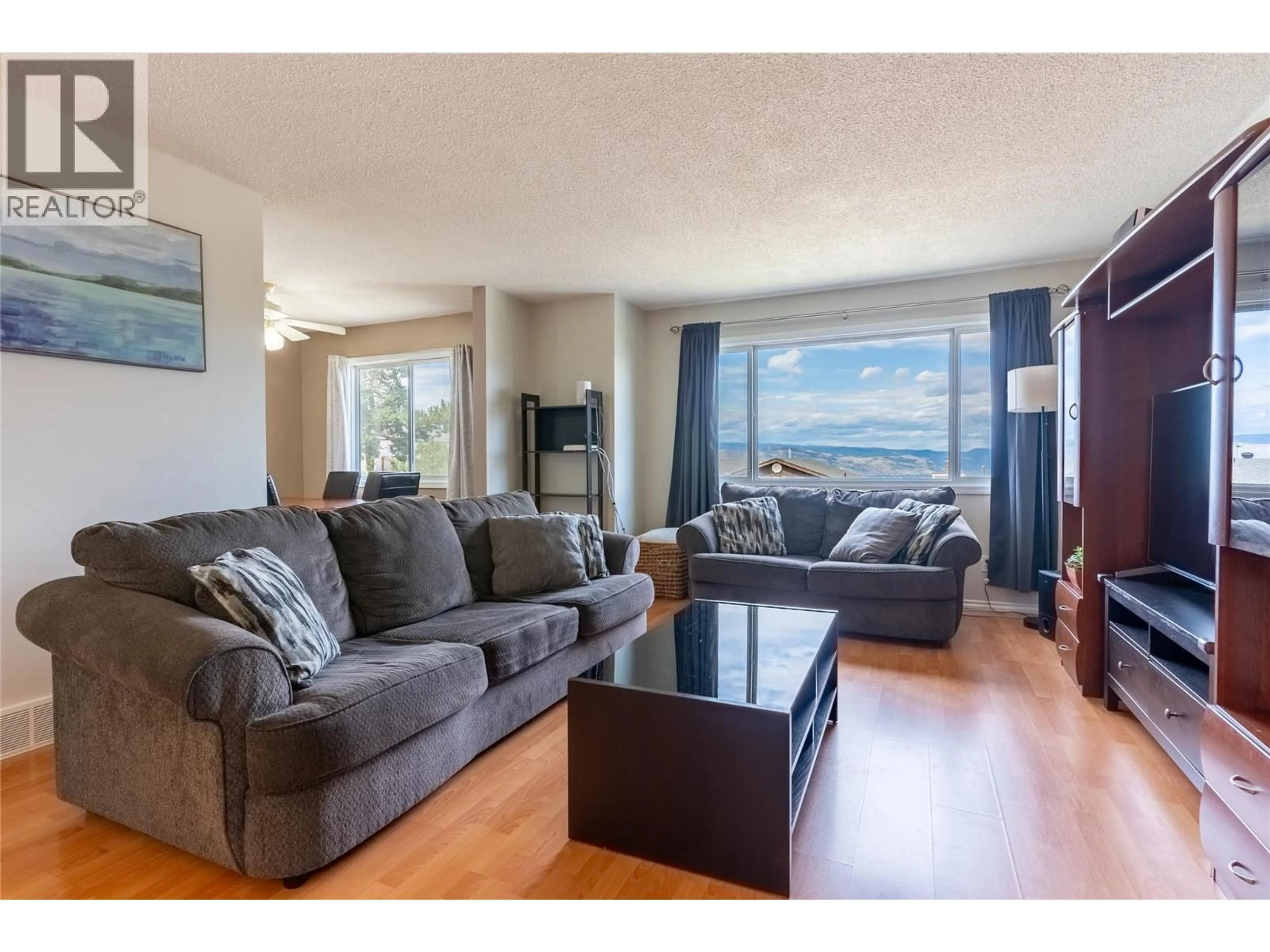 Living room with furniture, wood/laminate floor for 399 WADDINGTON DRIVE, Kamloops British Columbia V2E1S3