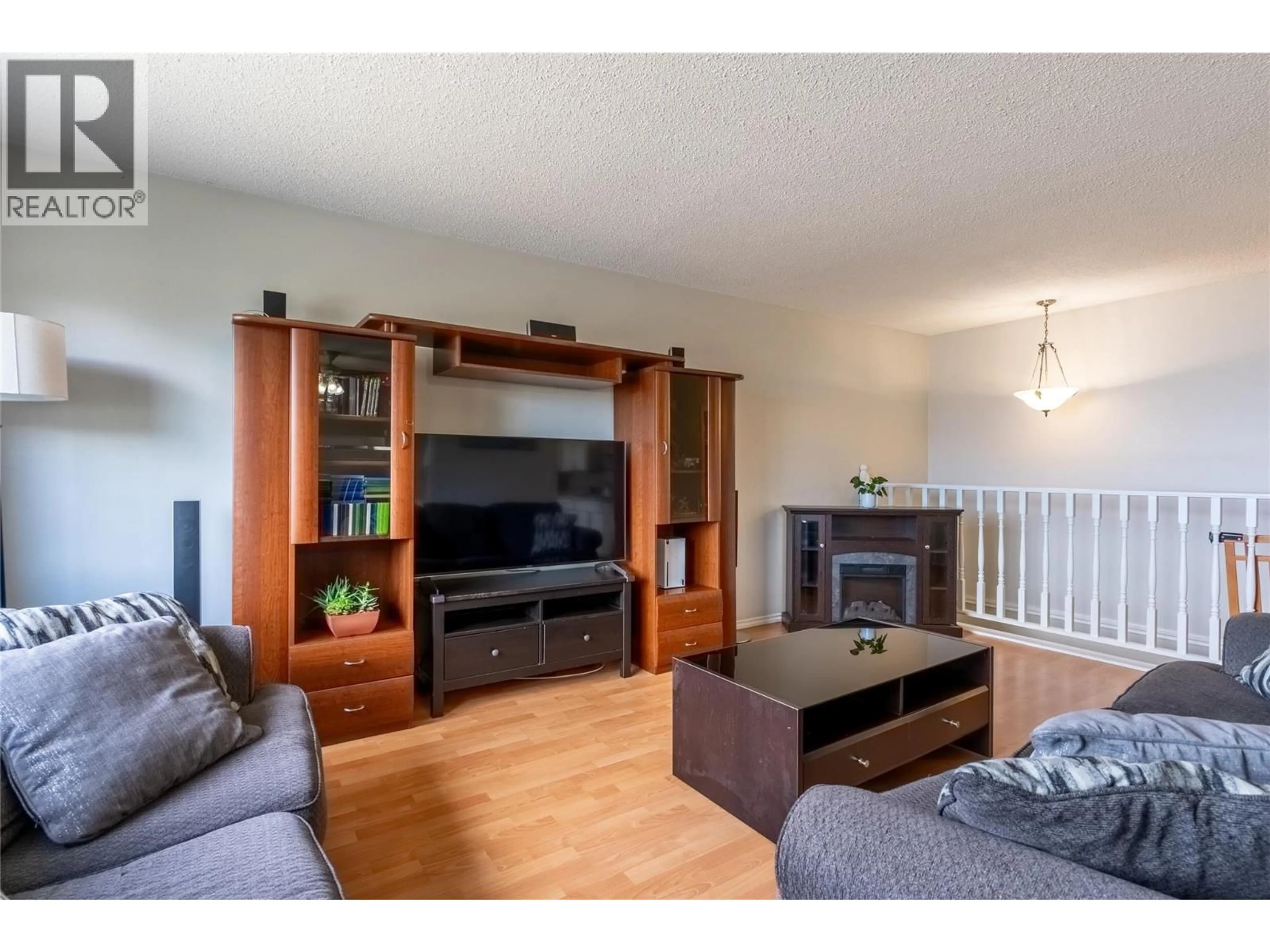 Living room with furniture, wood/laminate floor for 399 WADDINGTON DRIVE, Kamloops British Columbia V2E1S3