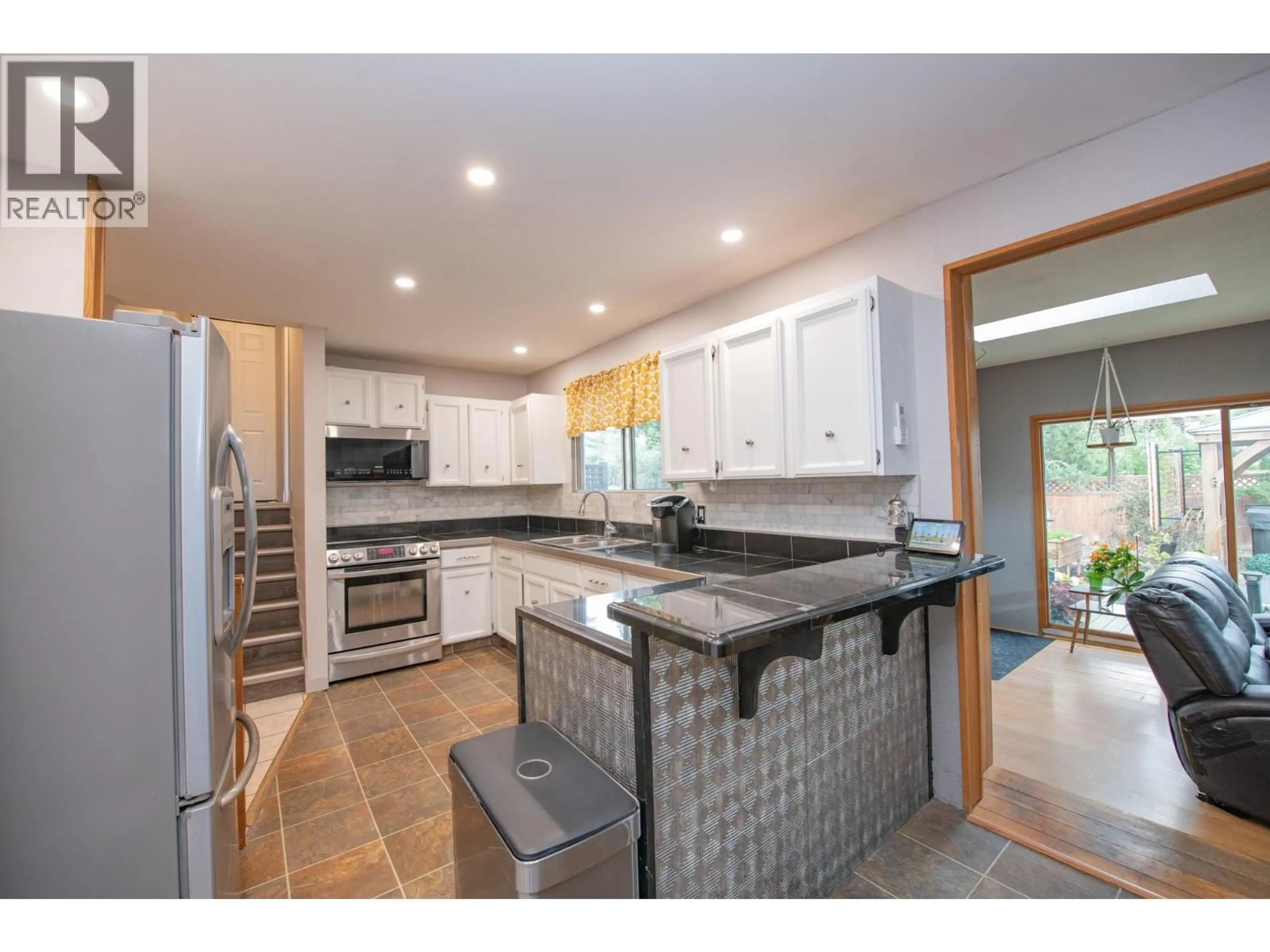 Open concept kitchen, ceramic/tile floor for 1390 CORNWALL ROAD, Kelowna British Columbia V1X1N9