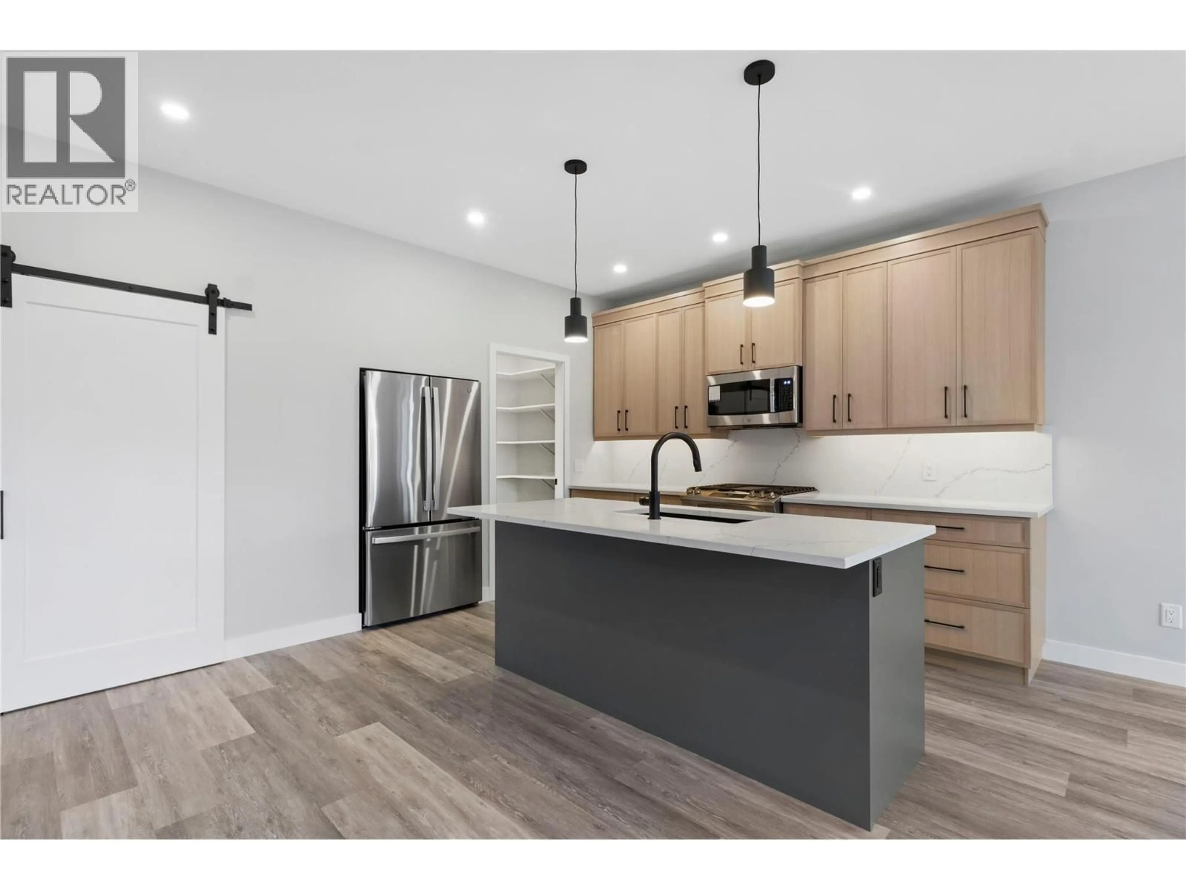 Open concept kitchen, wood/laminate floor for 2971 27 STREET NORTHEAST, Salmon Arm British Columbia V1E2Z7