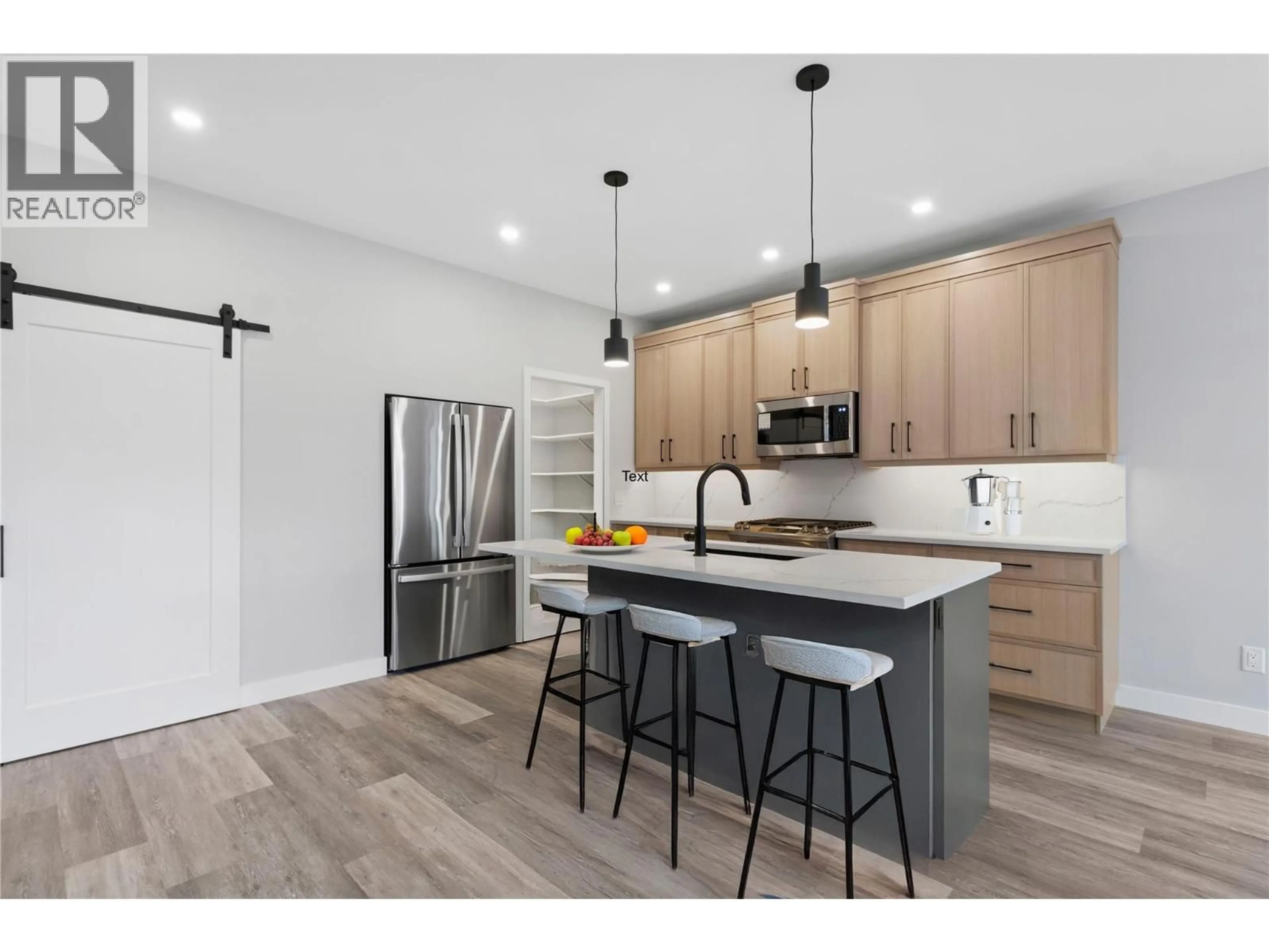 Open concept kitchen, wood/laminate floor for 2971 27 STREET NORTHEAST, Salmon Arm British Columbia V1E2Z7