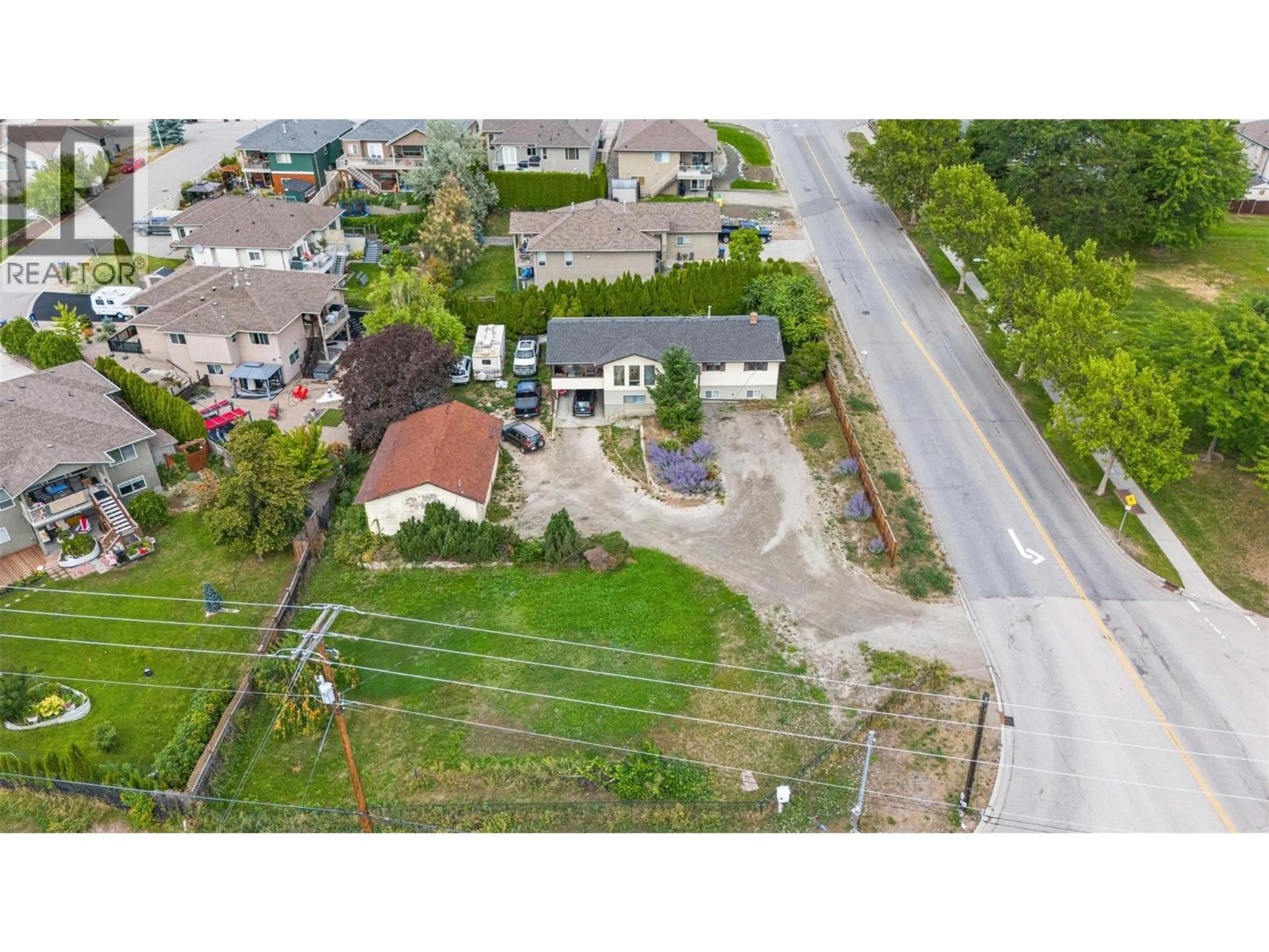 A pic from outside/outdoor area/front of a property/back of a property/a pic from drone, street for 1584 HIGHWAY 33 OTHER EAST, Kelowna British Columbia V1P1L9