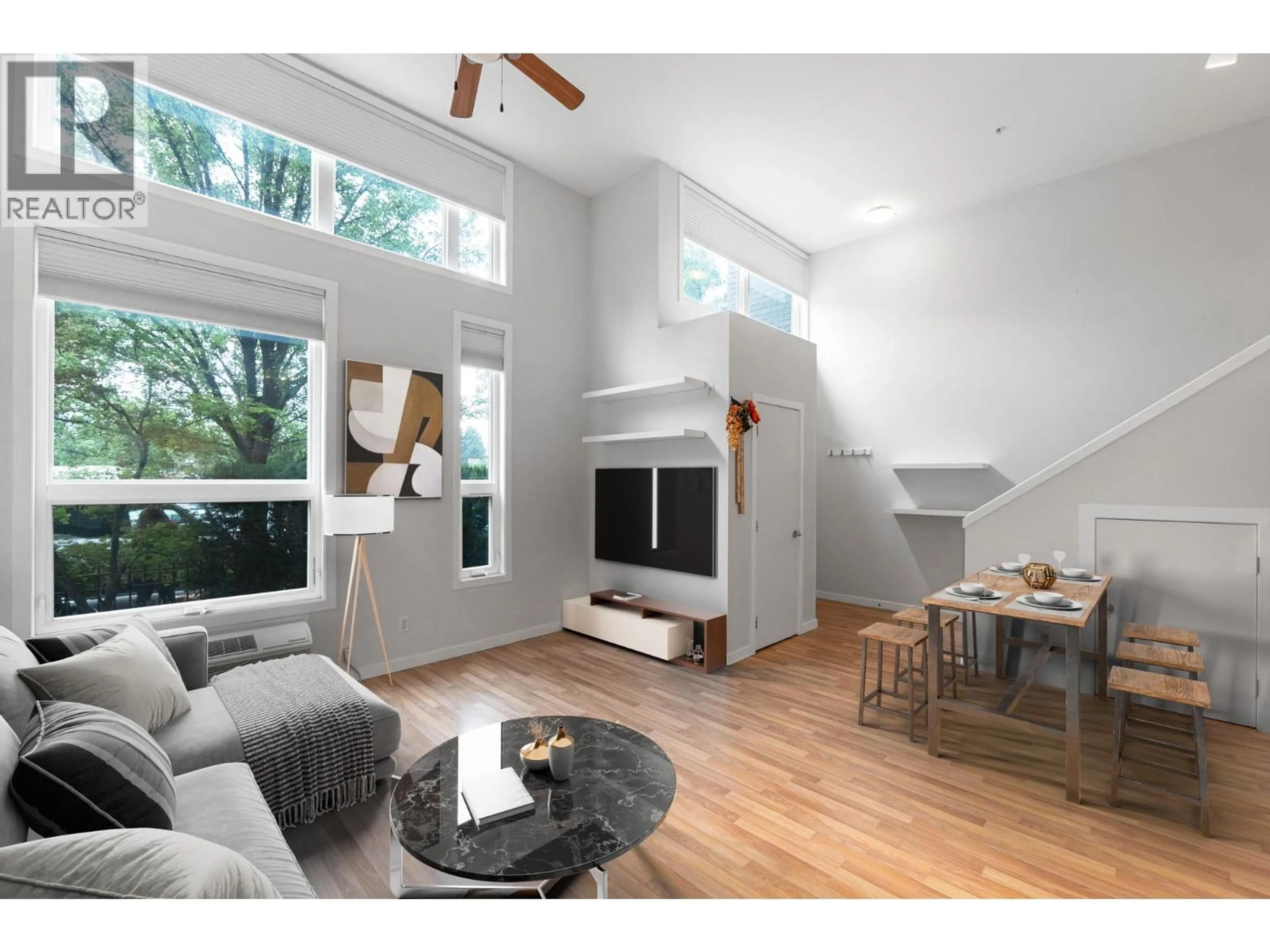 Living room with furniture, wood/laminate floor for 7 - 1550 DICKSON AVENUE, Kelowna British Columbia V1Y9Y8