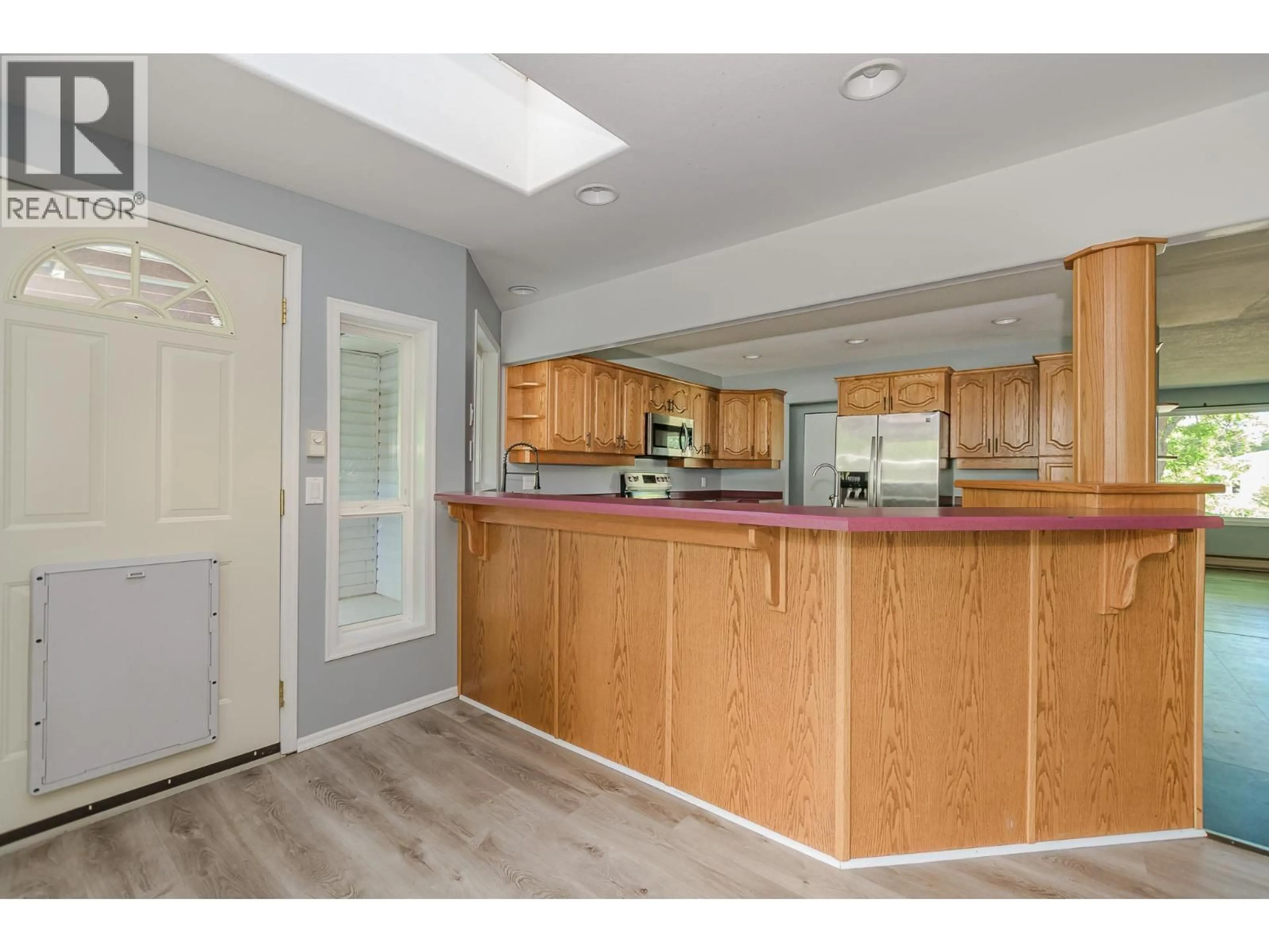 Open concept kitchen, wood/laminate floor for 714 MAPLE STREET, Sicamous British Columbia V0E2V1