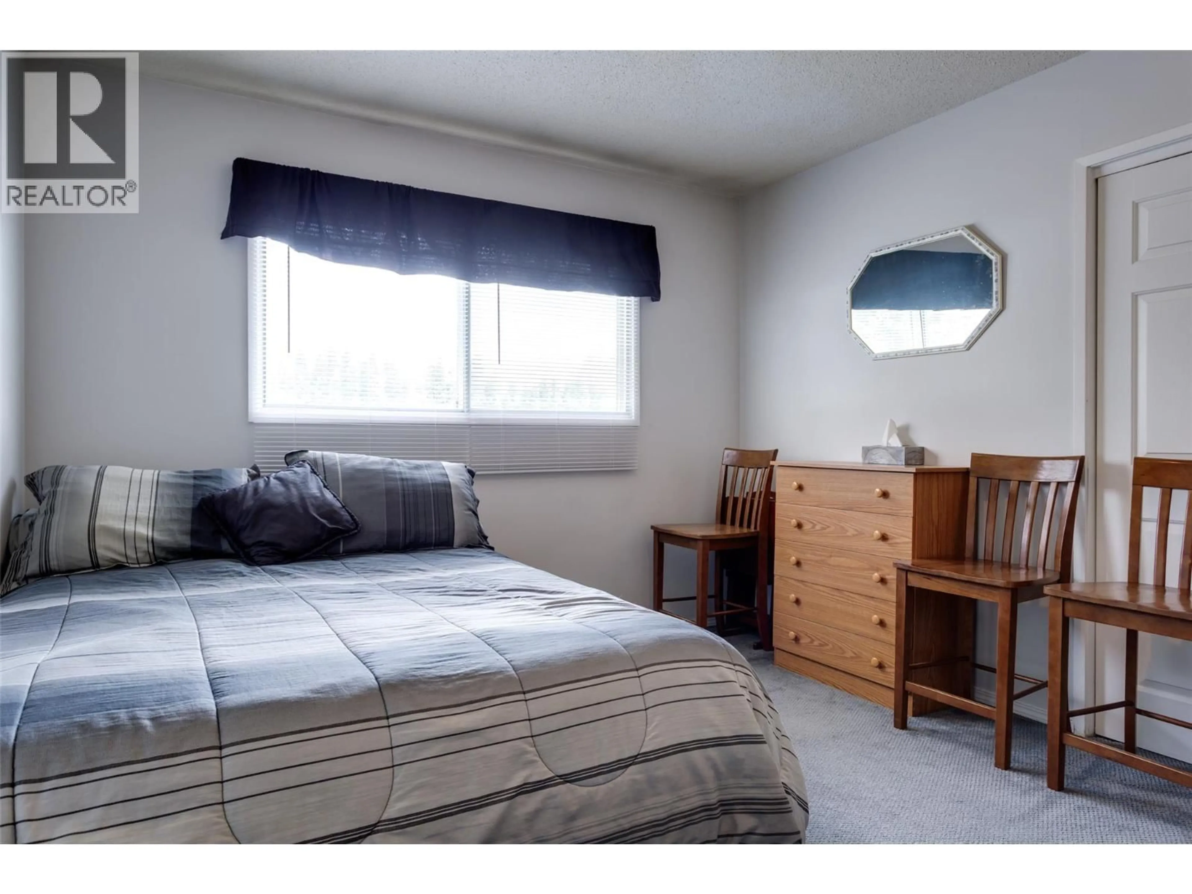 Bedroom with bed, wood/laminate floor for 685 QUIGLEY ROAD, Kelowna British Columbia V1X1A6