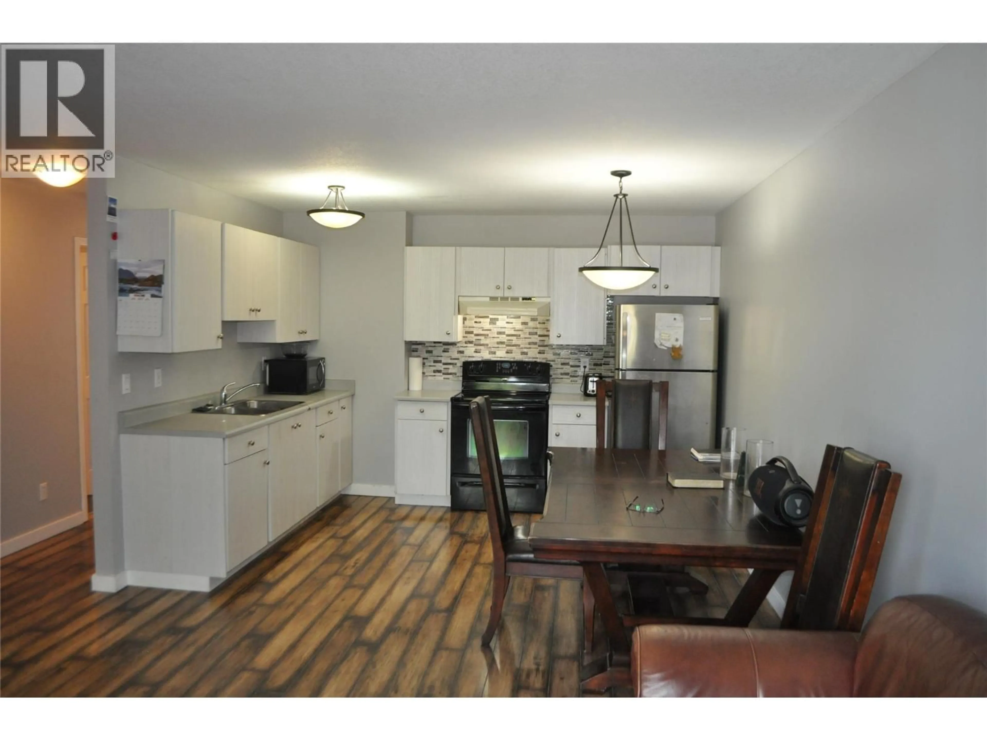 Open concept kitchen, wood/laminate floor for 109 - 1047 MIDDLETON WAY, Vernon British Columbia V1B2N3