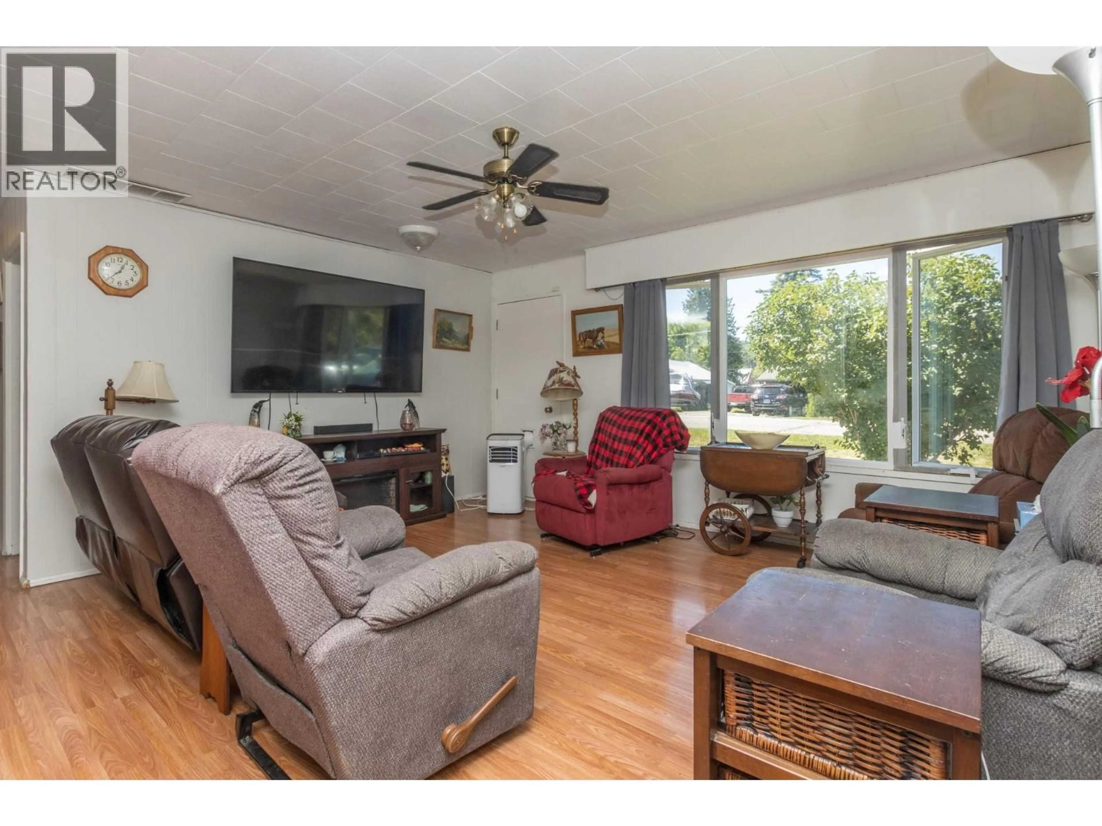 Living room with furniture, wood/laminate floor for 7050 54 STREET NORTHEAST, Salmon Arm British Columbia V0E1K0