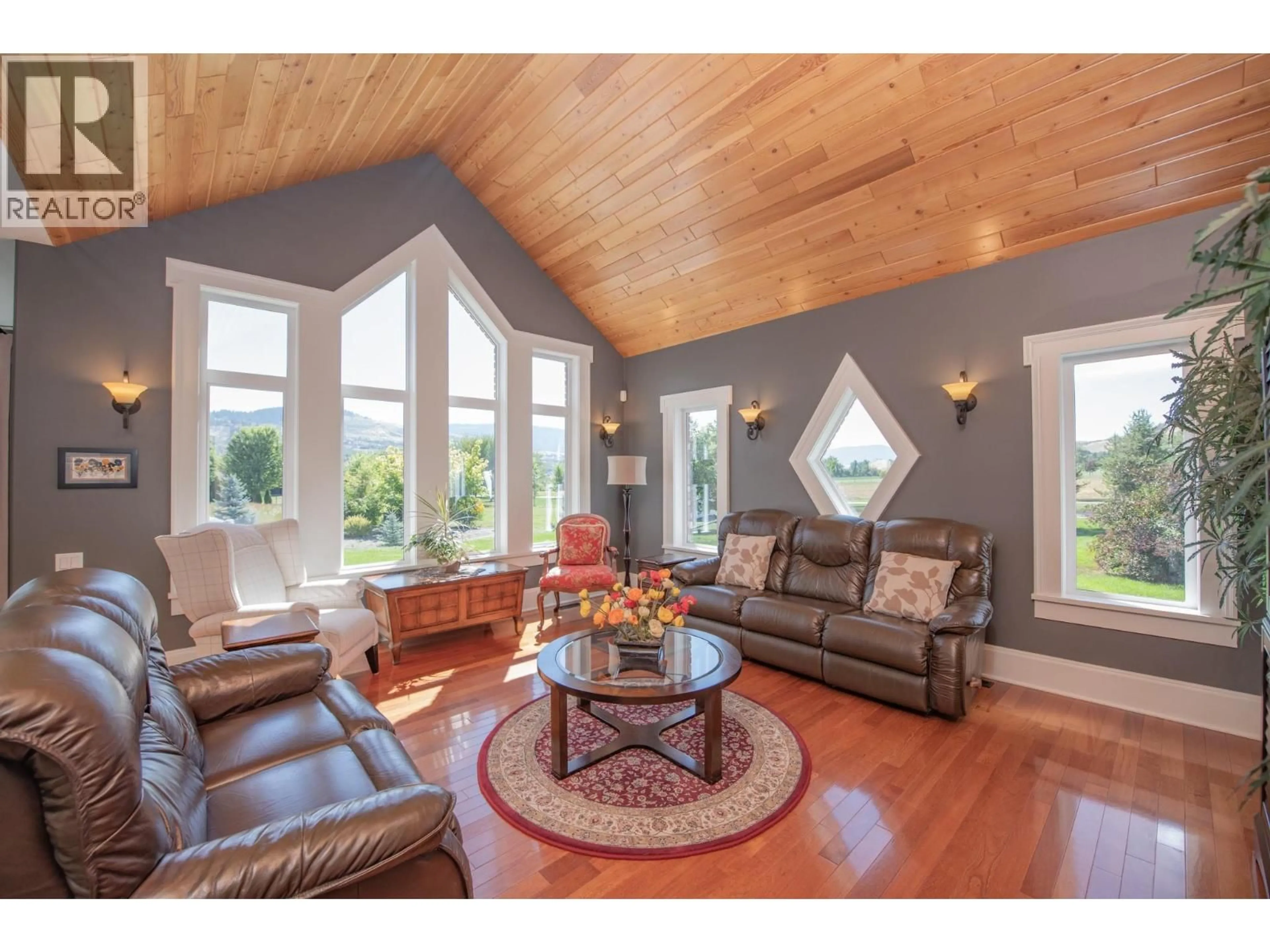 Living room with furniture, wood/laminate floor for 8163 OLD KAMLOOPS ROAD, Vernon British Columbia V1H1W8