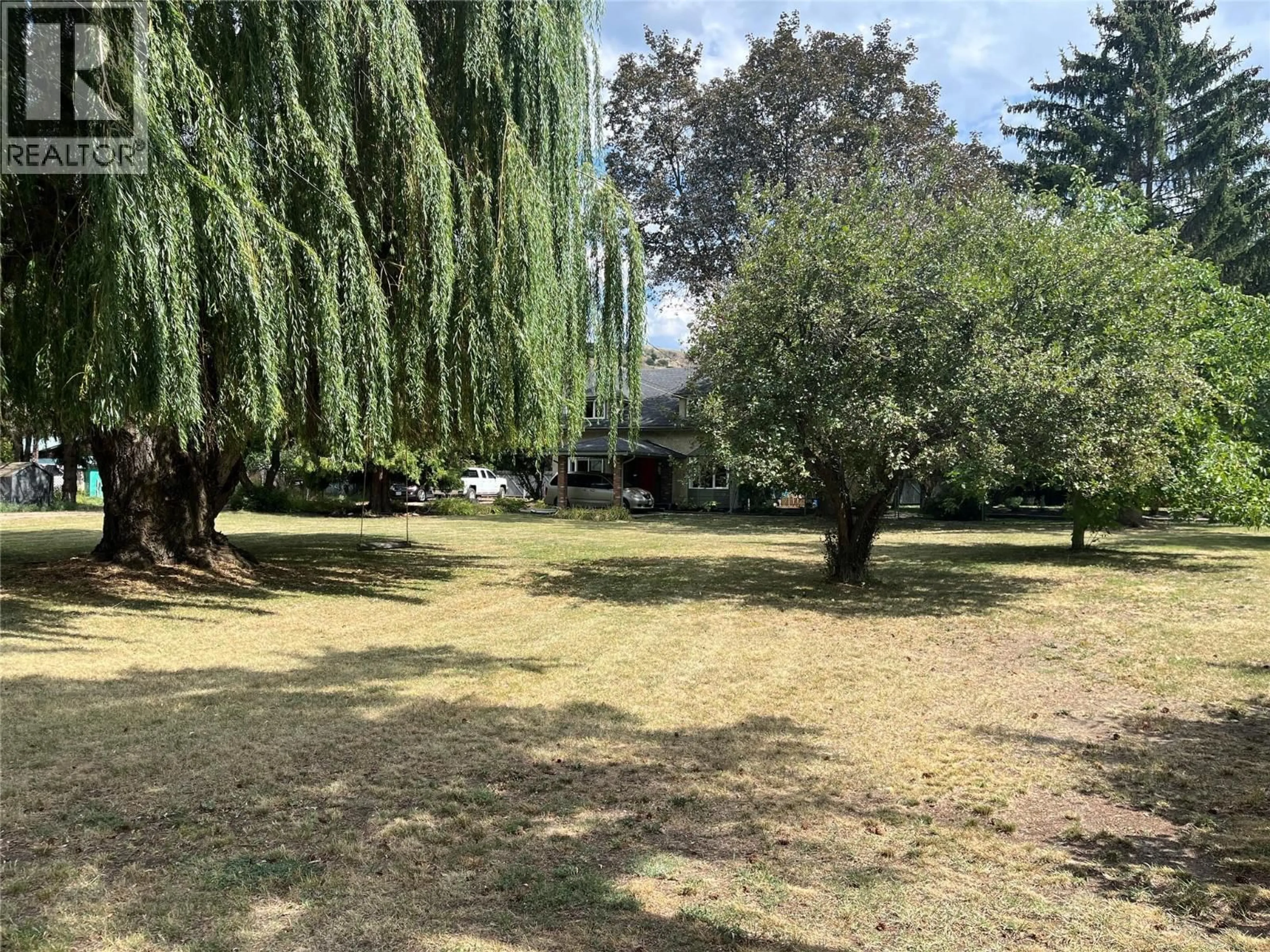 A pic from outside/outdoor area/front of a property/back of a property/a pic from drone, forest/trees view for 8303 POSTILL DRIVE, Coldstream British Columbia V1B1T9