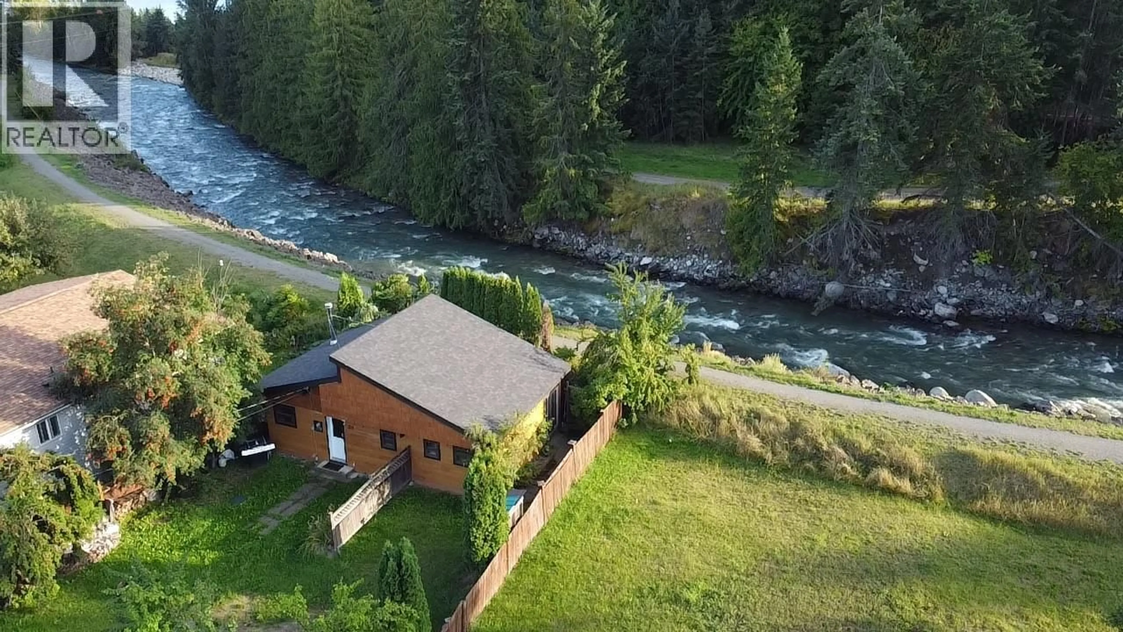 A pic from outside/outdoor area/front of a property/back of a property/a pic from drone, water/lake/river/ocean view for 328 RIVER LANE, Kaslo British Columbia V0G1M0