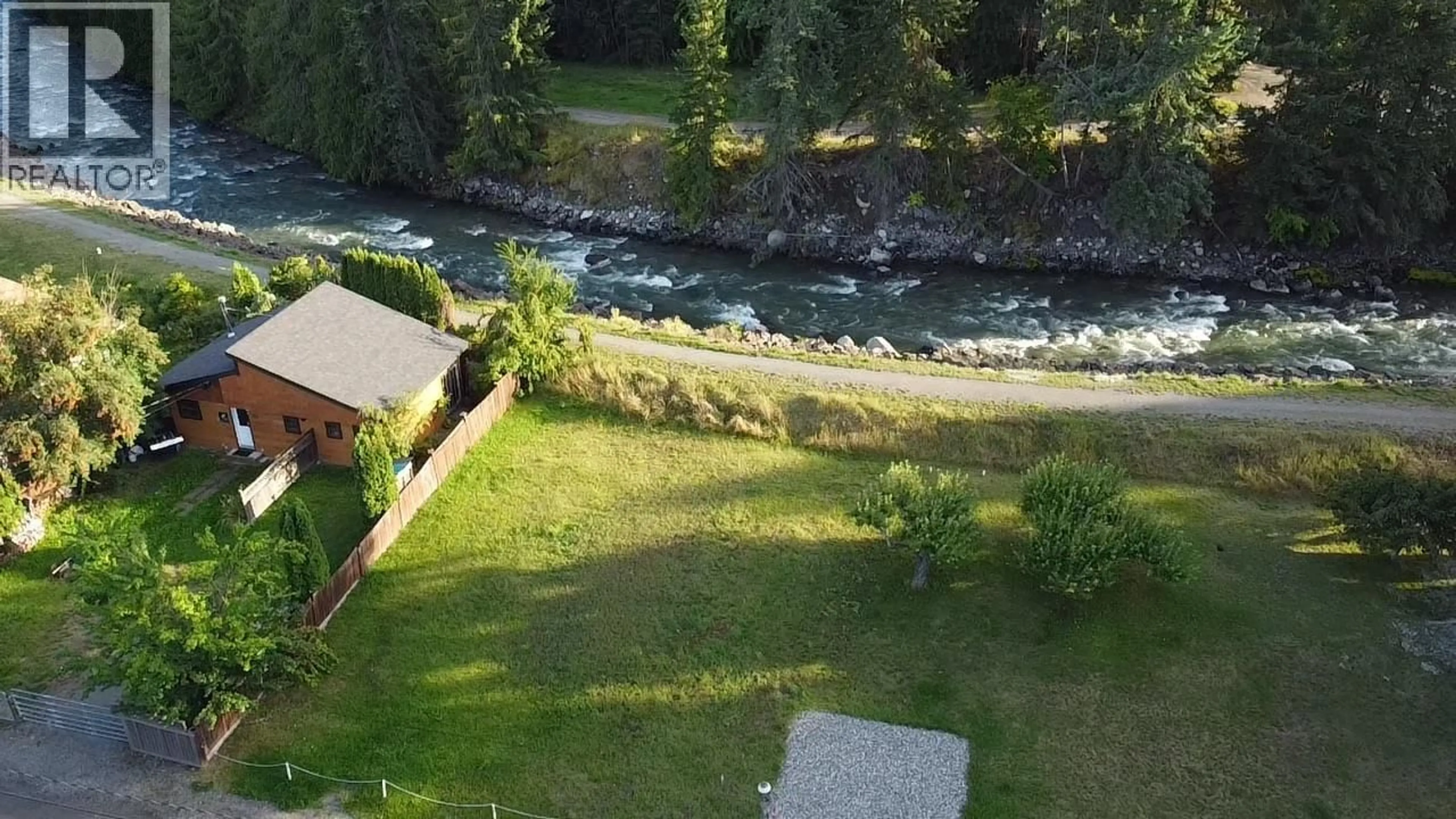 A pic from outside/outdoor area/front of a property/back of a property/a pic from drone, water/lake/river/ocean view for 328 RIVER LANE, Kaslo British Columbia V0G1M0