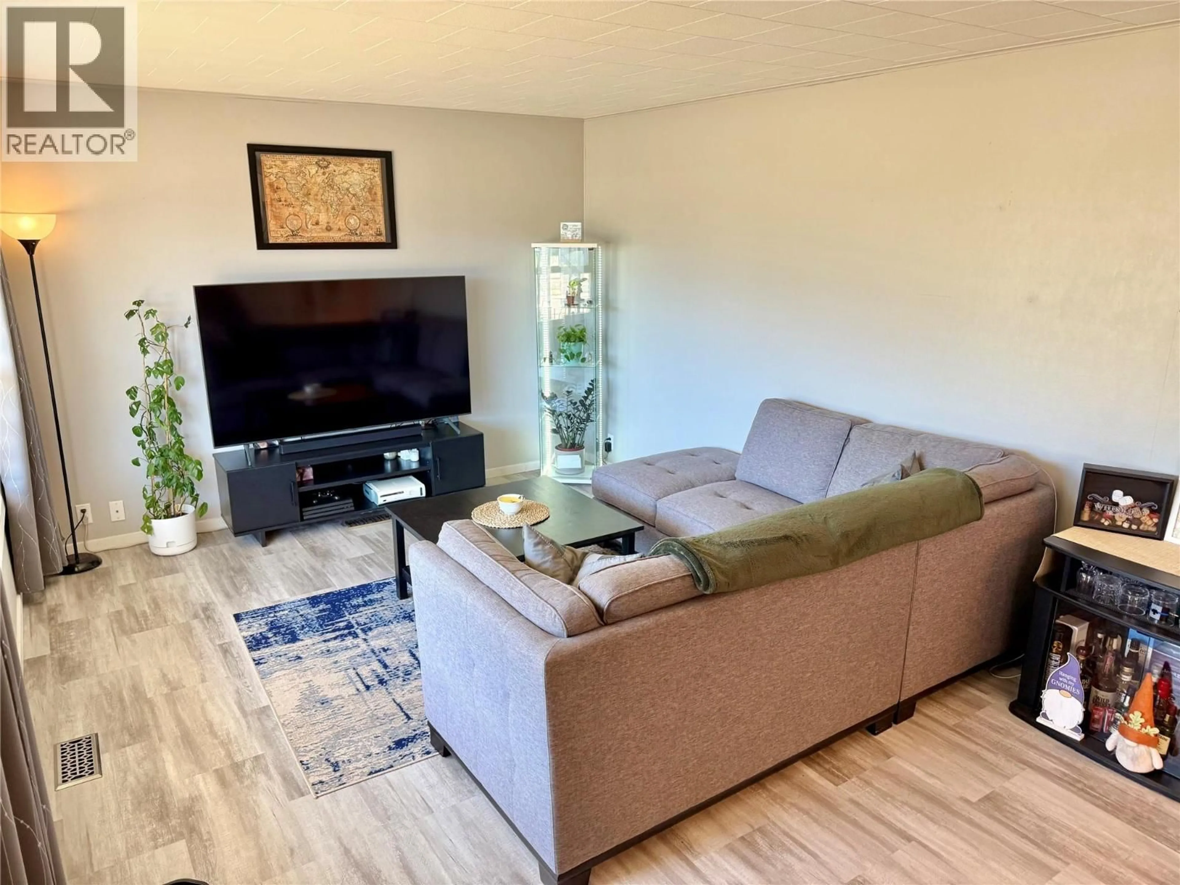 Living room with furniture, wood/laminate floor for 1971 75 AVENUE, Grand Forks British Columbia V0H1H2
