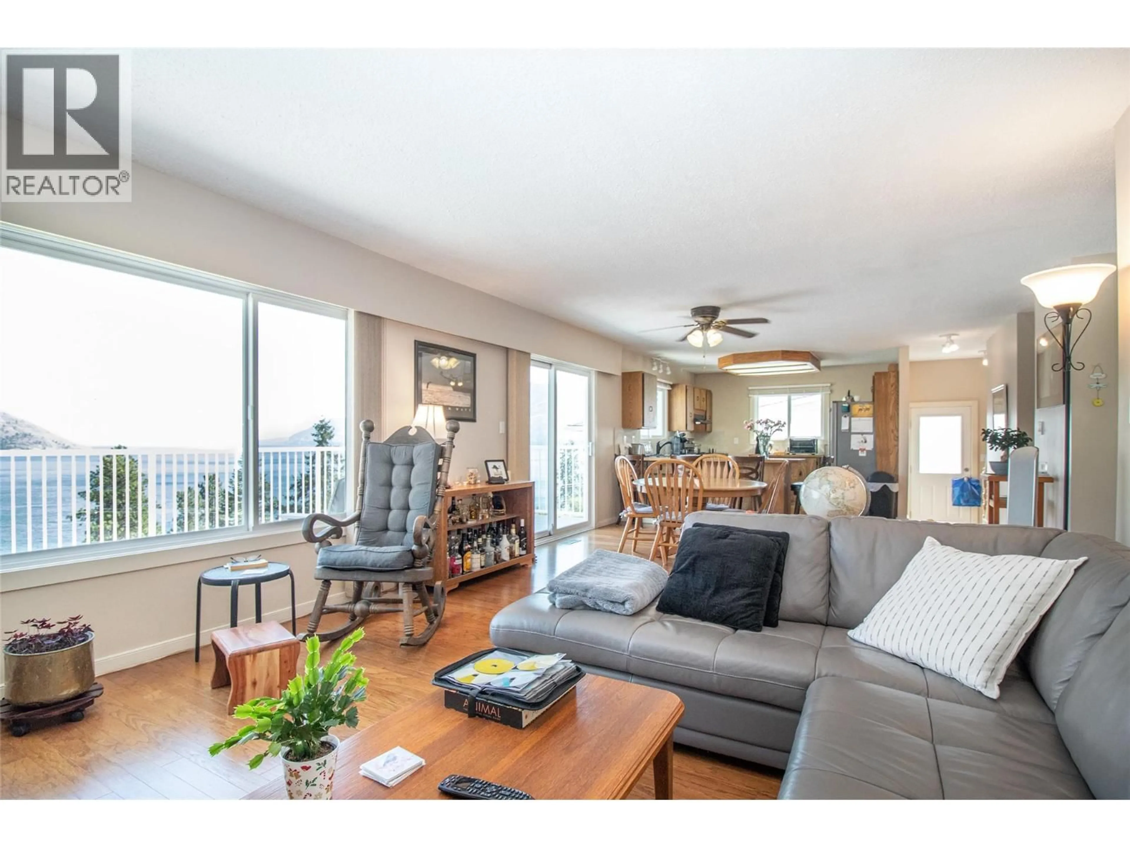 Living room with furniture, wood/laminate floor for 6335 TOPHAM PLACE, Peachland British Columbia V0H1X0