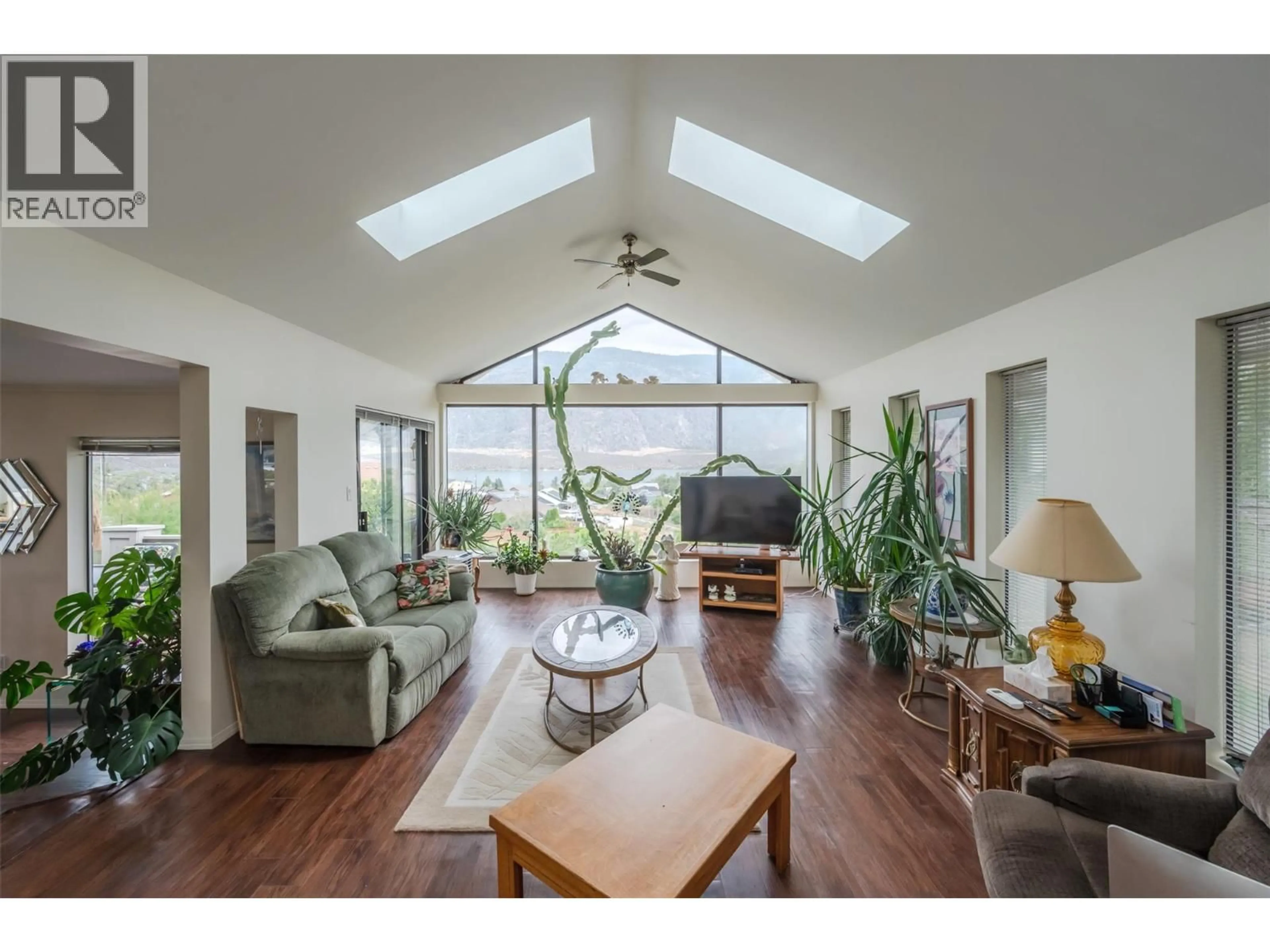 Living room with furniture, wood/laminate floor for 8507 92ND AVENUE, Osoyoos British Columbia V0H1V2