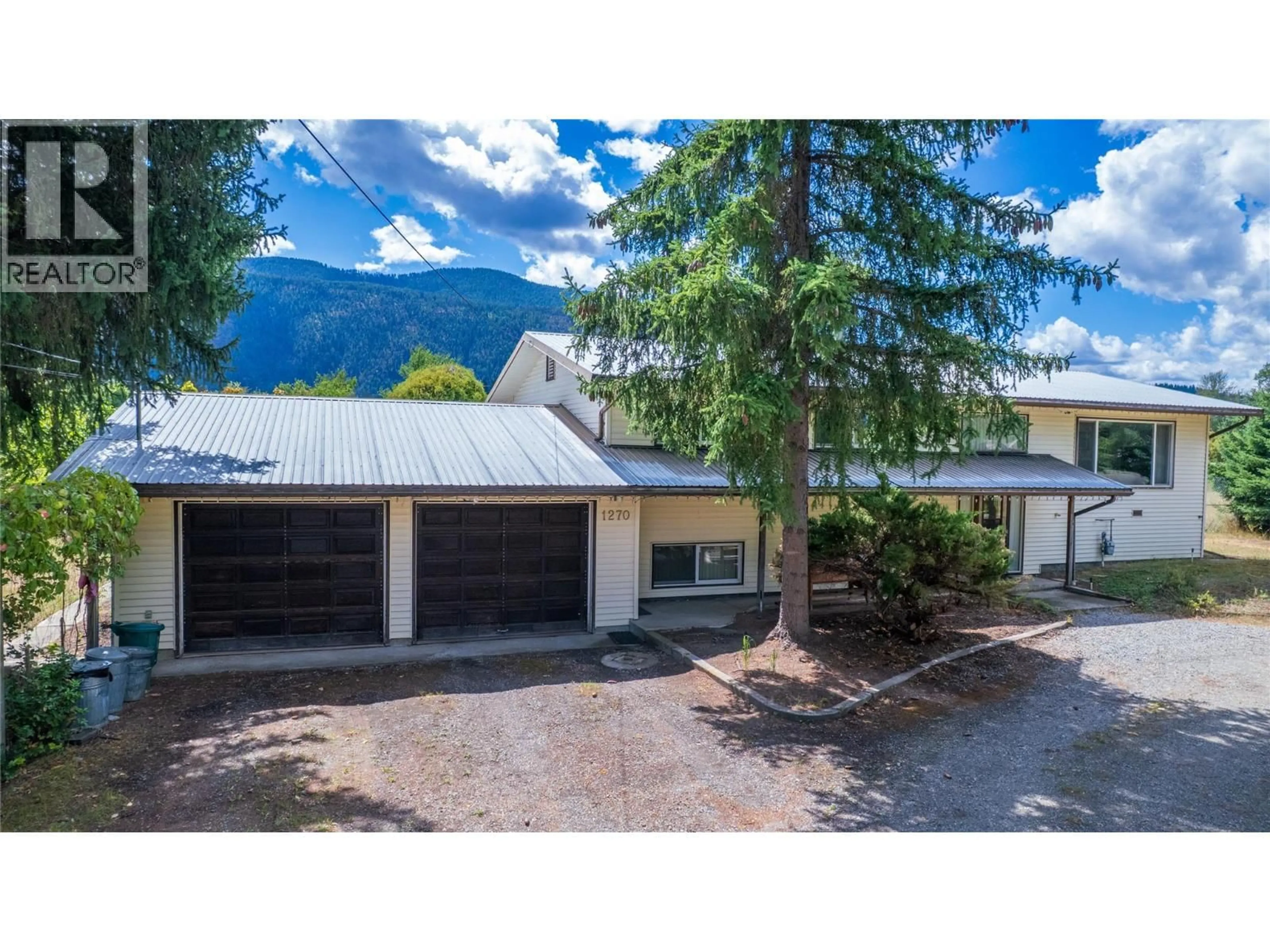 A pic from outside/outdoor area/front of a property/back of a property/a pic from drone, mountain view for 1270 59 AVENUE, Grand Forks British Columbia V0H1H0