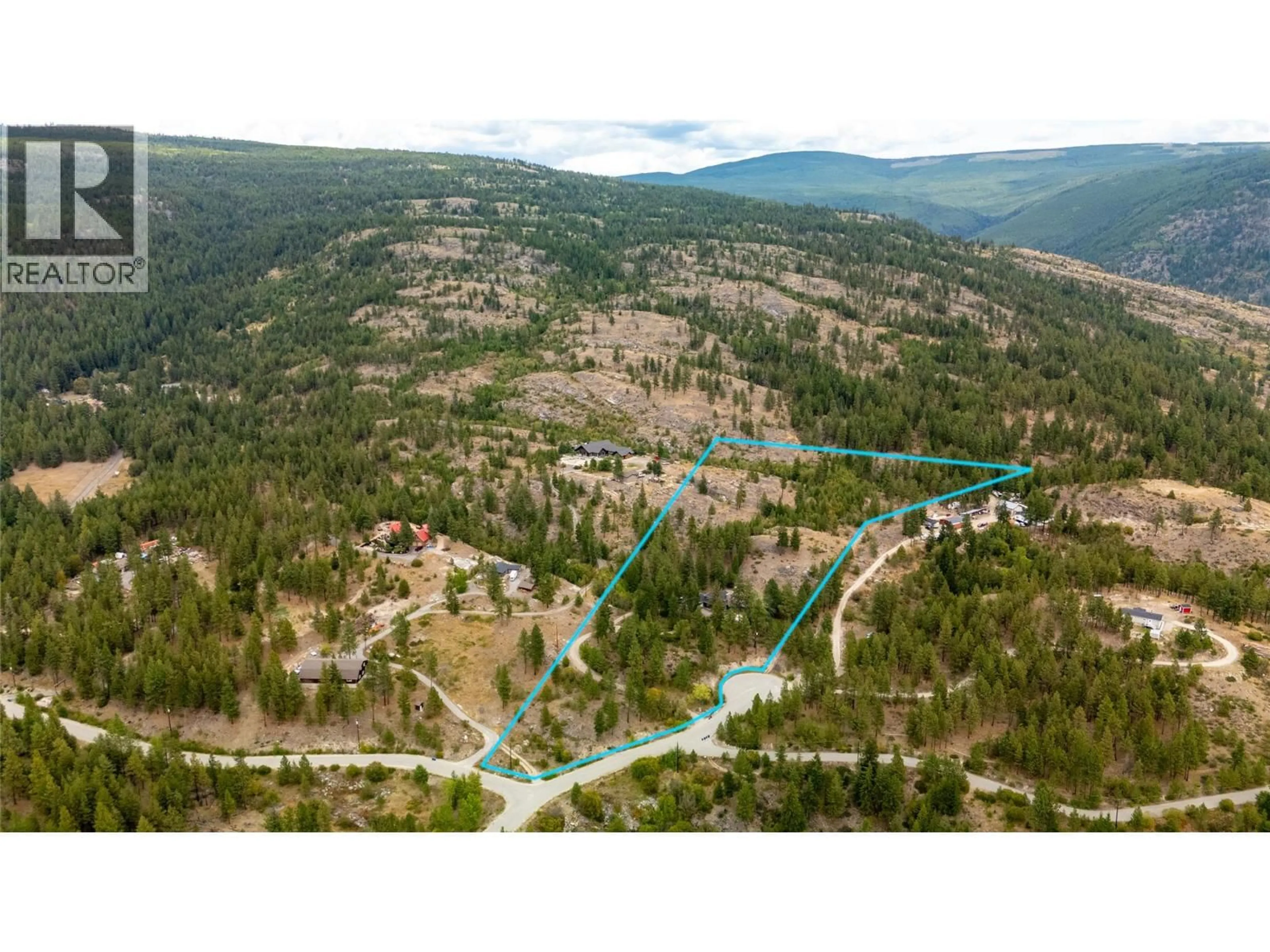 A pic from outside/outdoor area/front of a property/back of a property/a pic from drone, forest/trees view for 147 PINETREE WAY, Penticton British Columbia V2A8T3