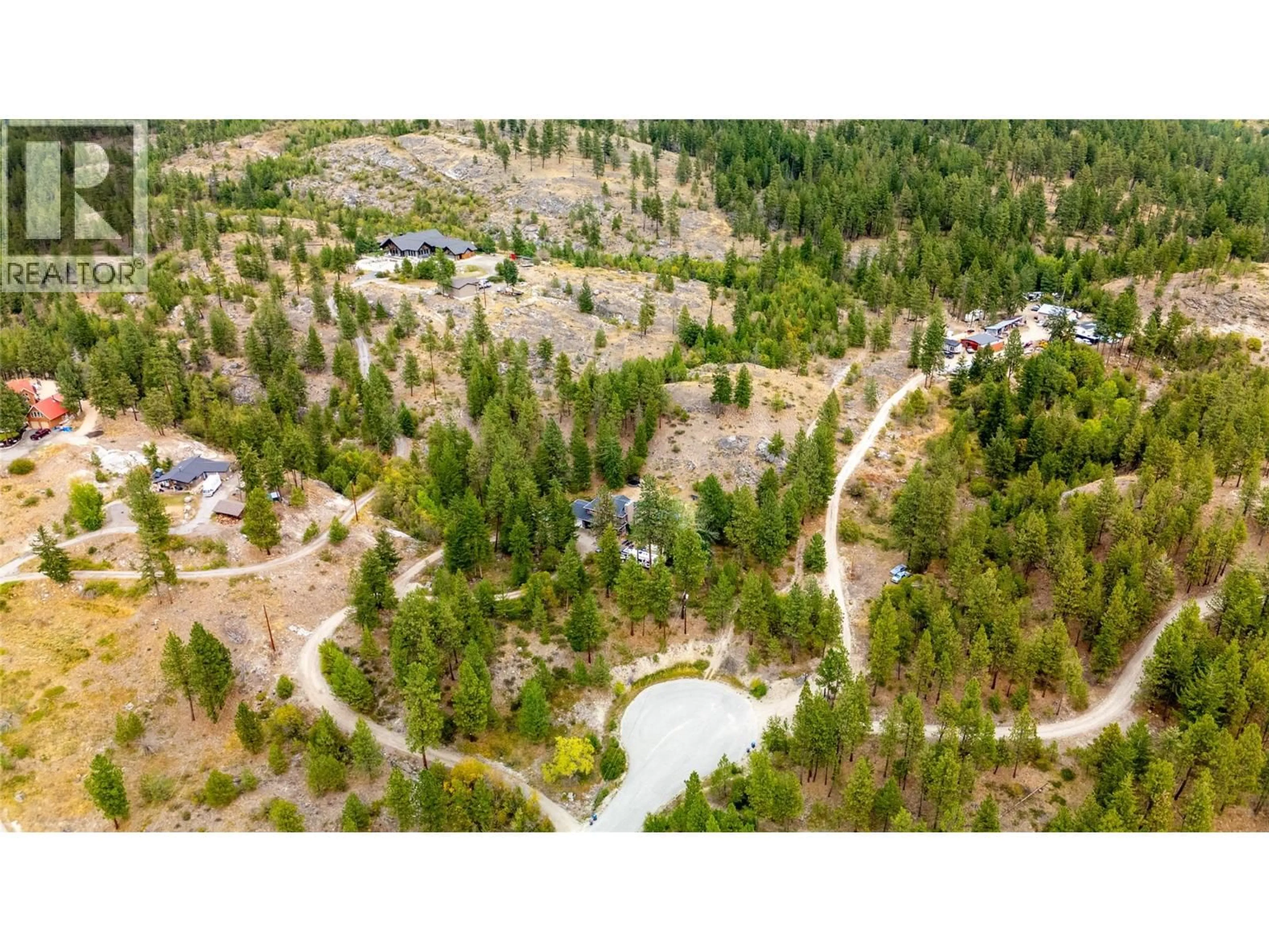 A pic from outside/outdoor area/front of a property/back of a property/a pic from drone, forest/trees view for 147 PINETREE WAY, Penticton British Columbia V2A8T3