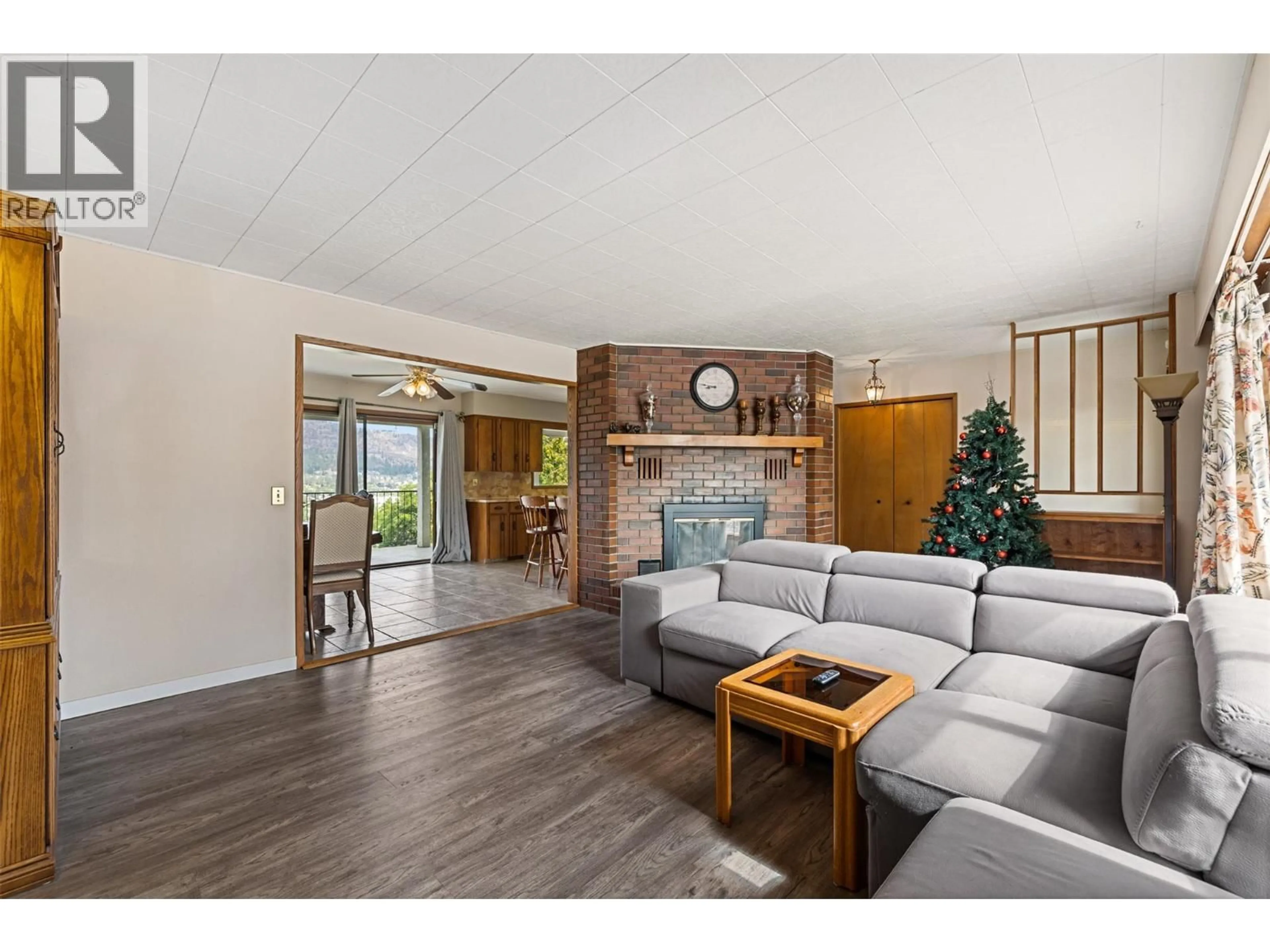 Living room with furniture, wood/laminate floor for 2354 ROJEM ROAD, Kelowna British Columbia V1Y7P9