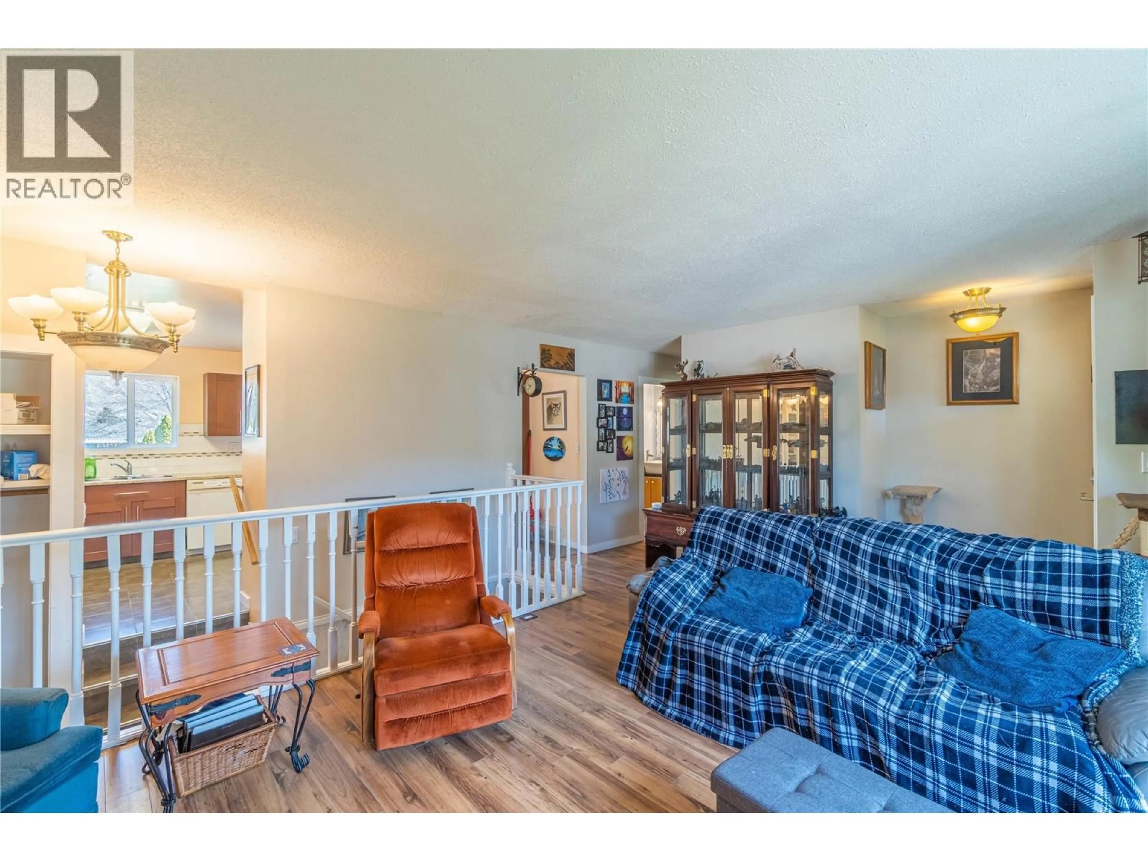 Living room with furniture, wood/laminate floor for 6418 FURRER ROAD, Kamloops British Columbia V2C4V6