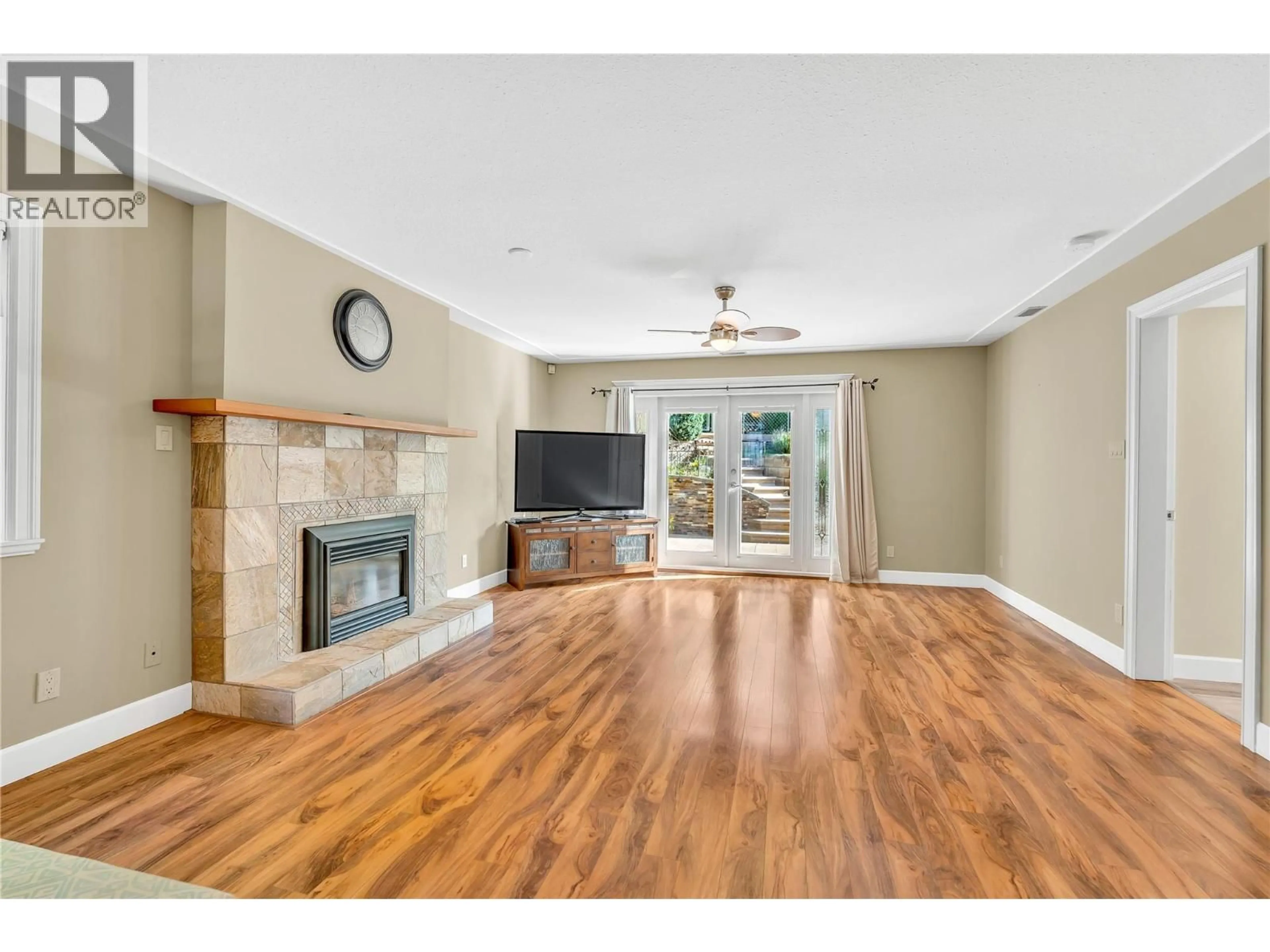 Living room with furniture, wood/laminate floor for 144 WILTSE PLACE, Penticton British Columbia V2A7V6