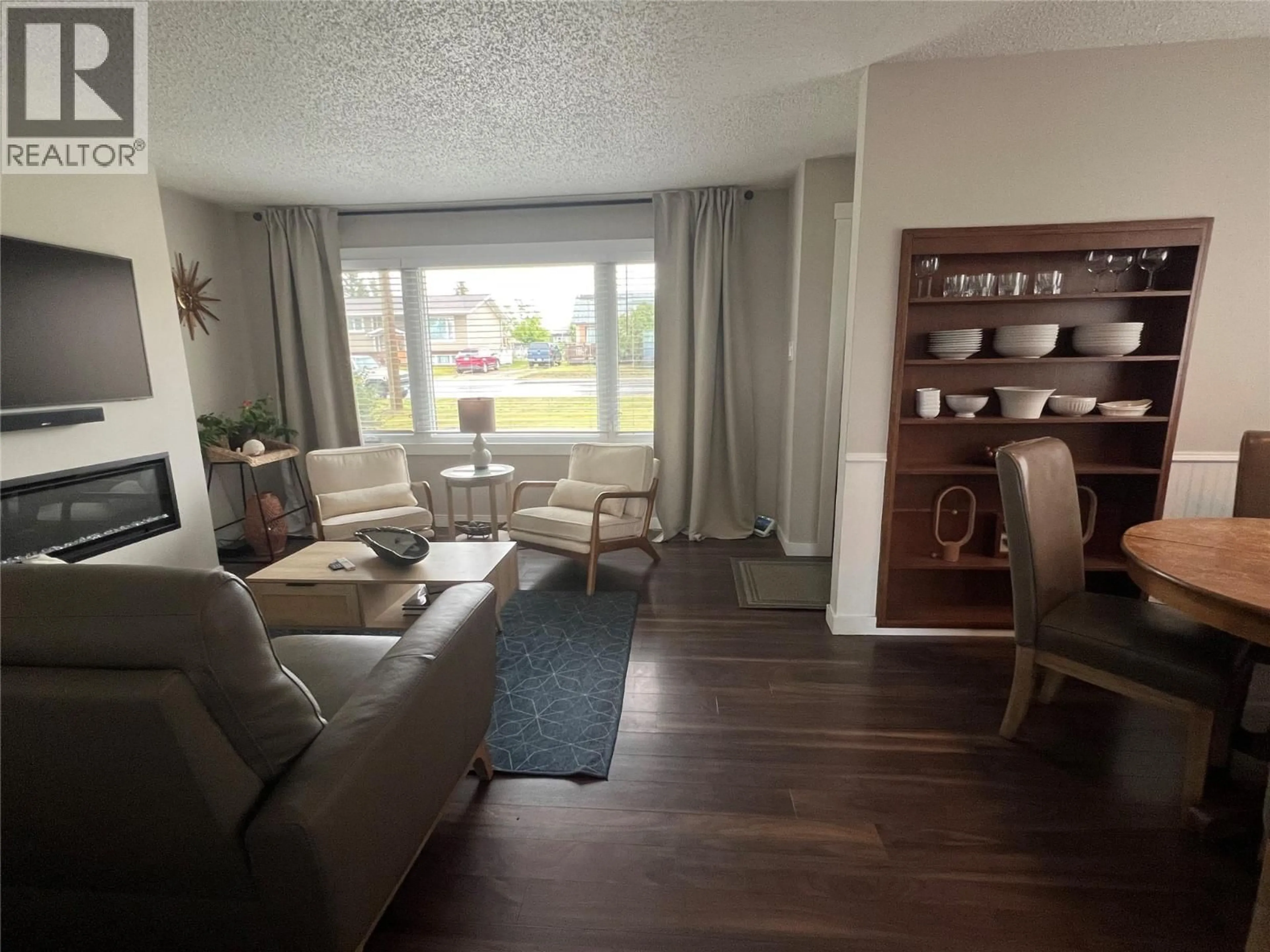Living room with furniture, wood/laminate floor for 1121 96 AVENUE, Dawson Creek British Columbia V1G1L2