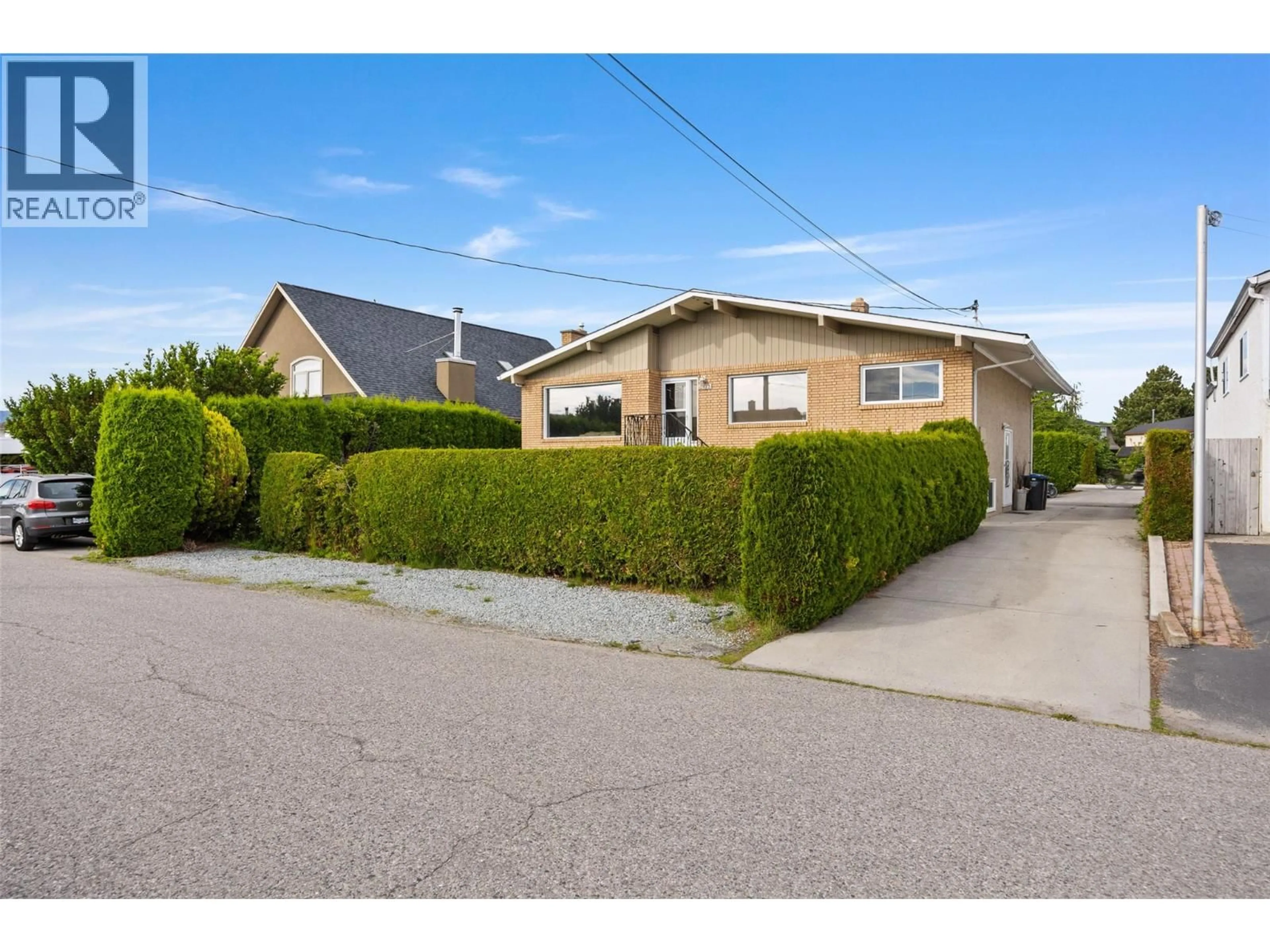 A pic from outside/outdoor area/front of a property/back of a property/a pic from drone, street for 3473 MOBERLY ROAD, Kelowna British Columbia V1W3H9