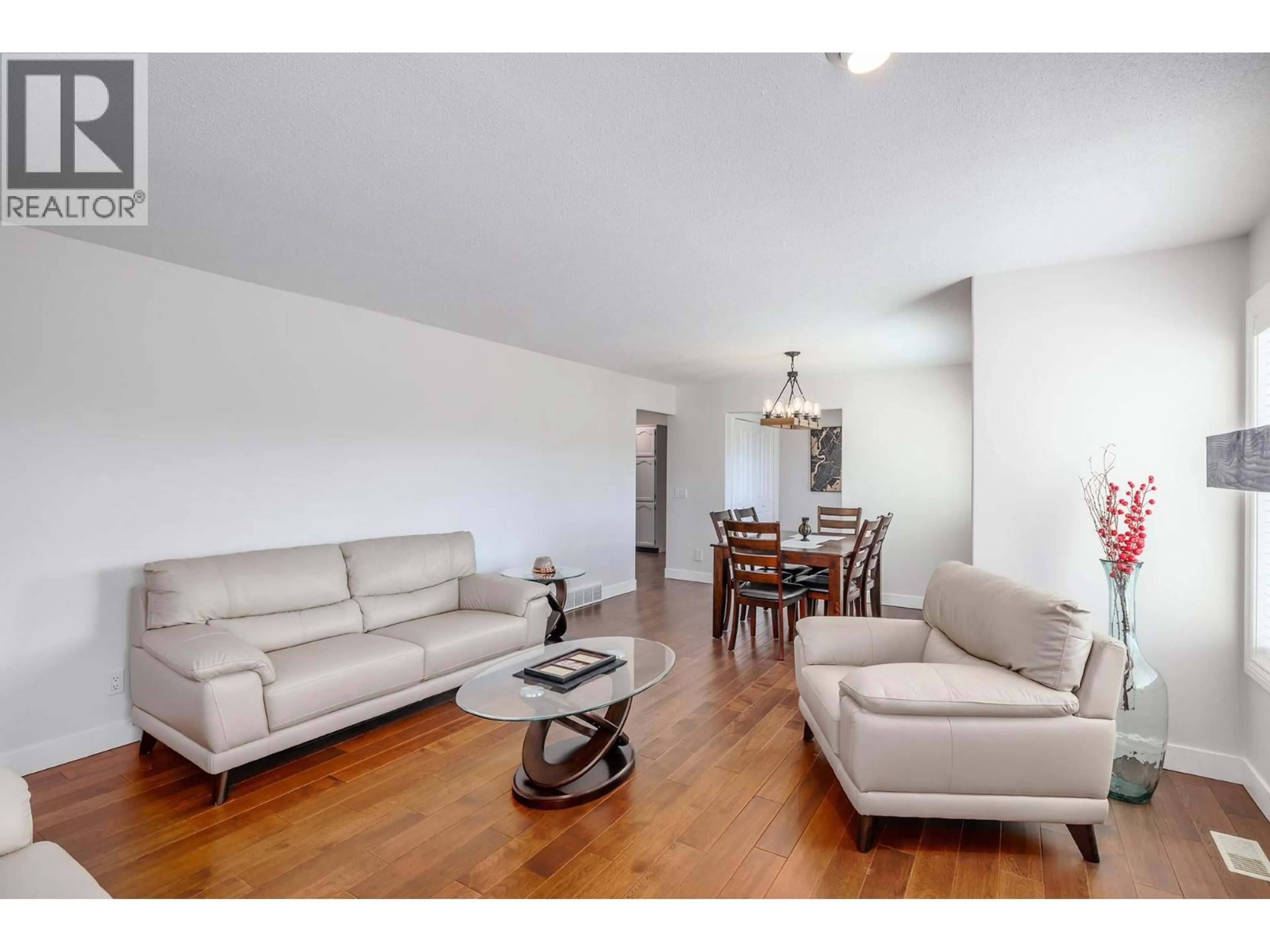 Living room with furniture, wood/laminate floor for 70 - 615 GLENMEADOWS ROAD, Kelowna British Columbia V1V1N9