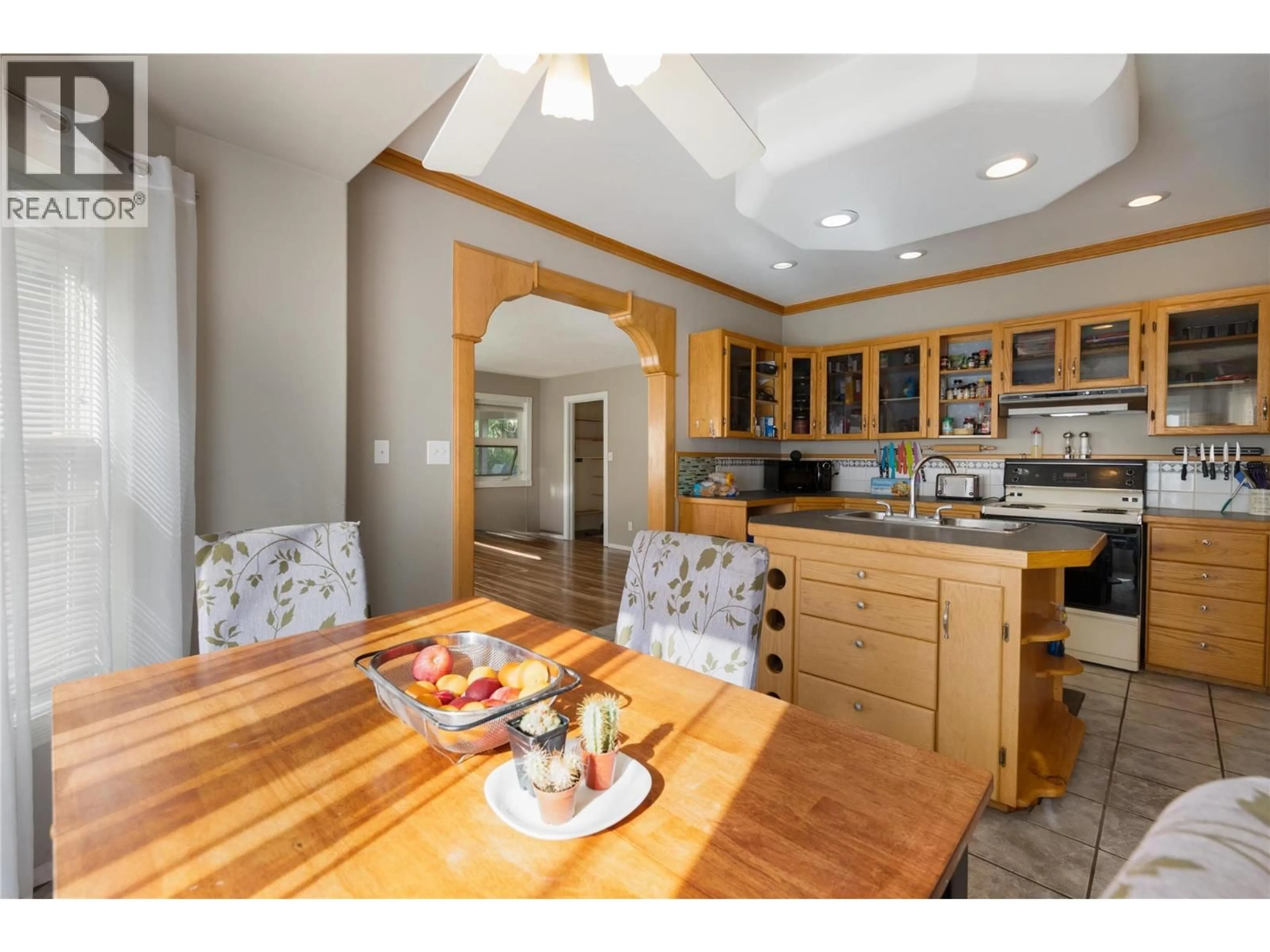 Open concept kitchen, wood/laminate floor for 7630 97A HIGHWAY, Mara British Columbia V0E2K0
